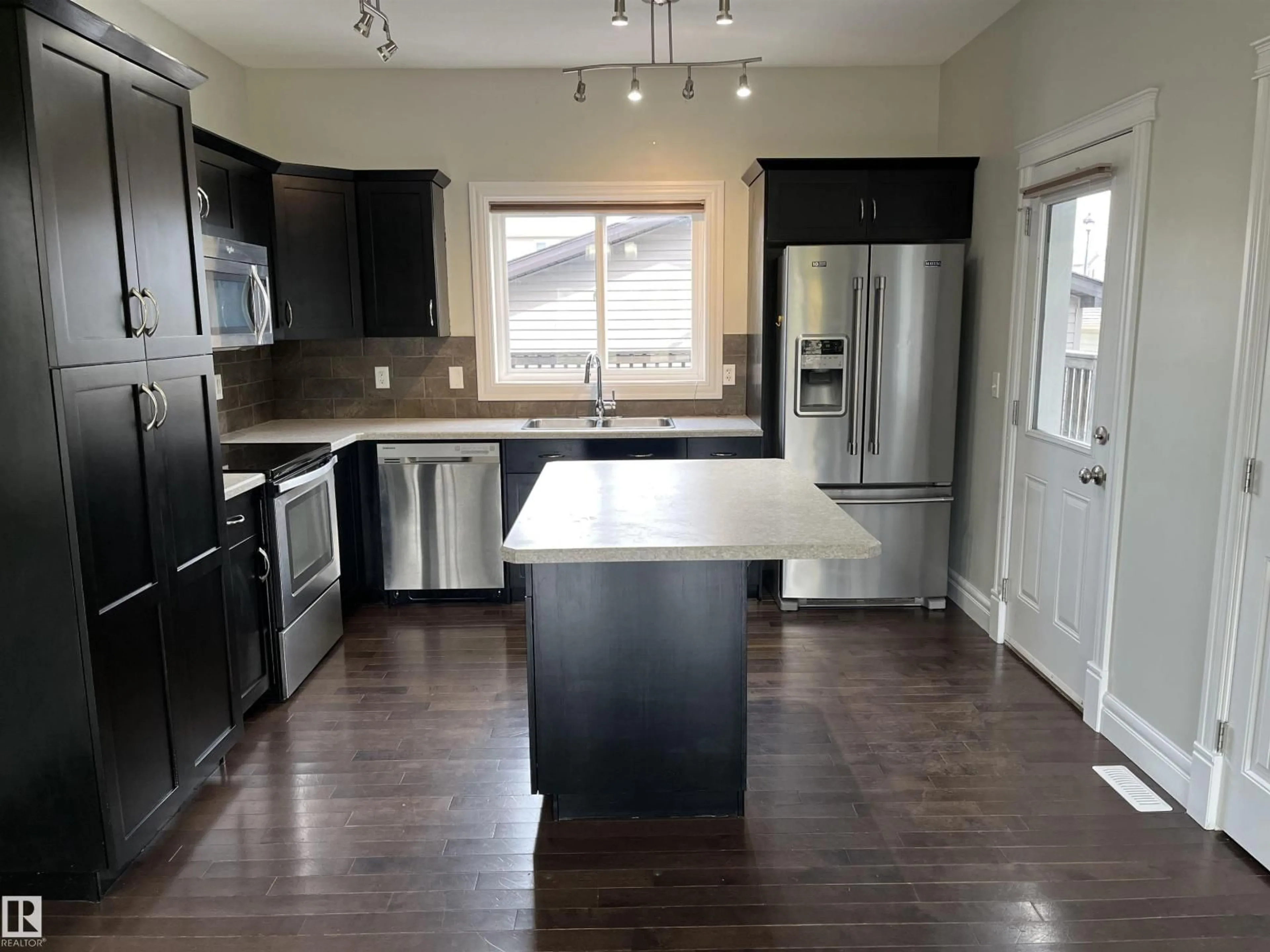 Open concept kitchen, wood/laminate floor for 303 SHERIDAN WY, Leduc Alberta T9E8R9