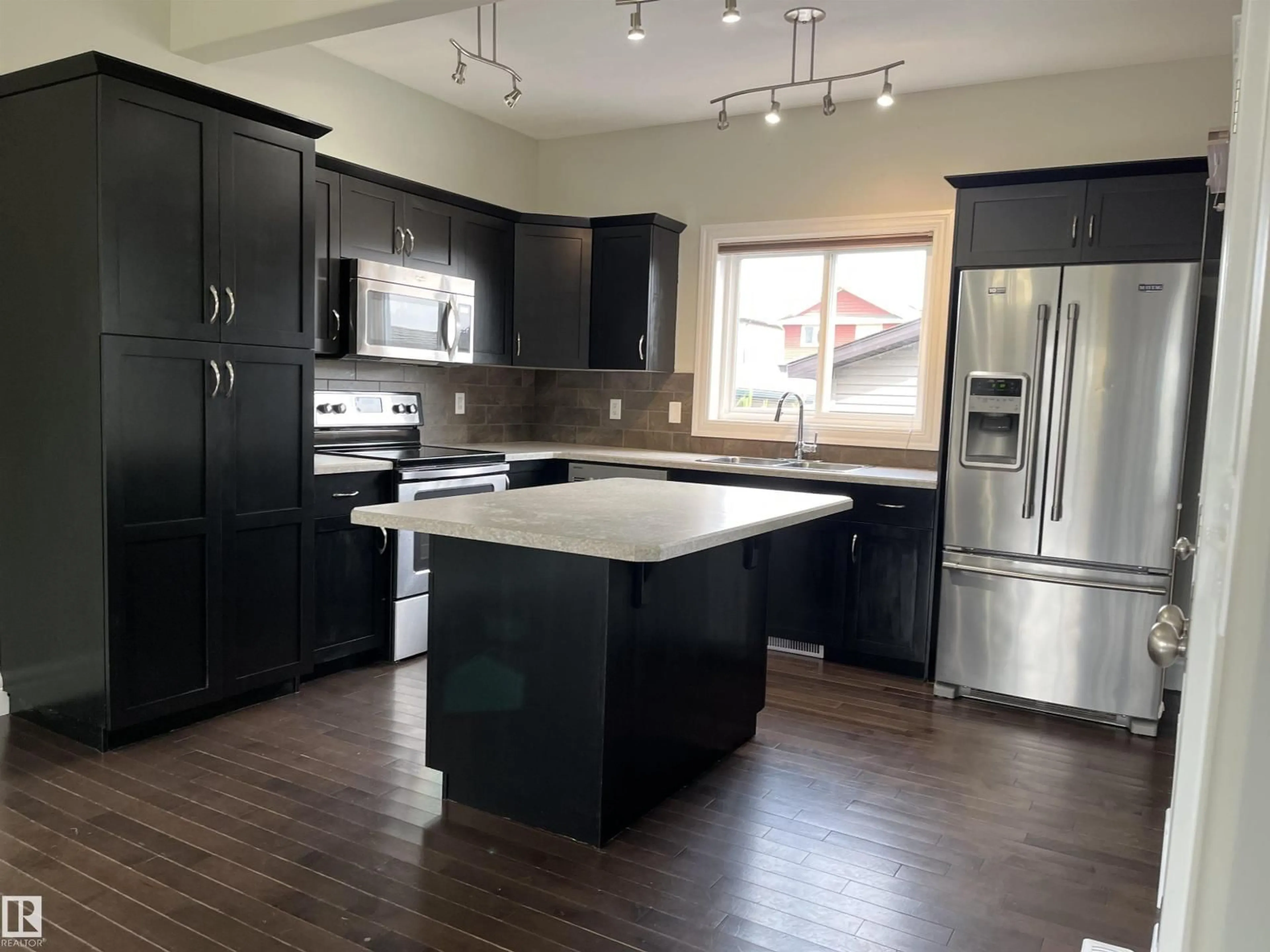 Open concept kitchen, wood/laminate floor for 303 SHERIDAN WY, Leduc Alberta T9E8R9