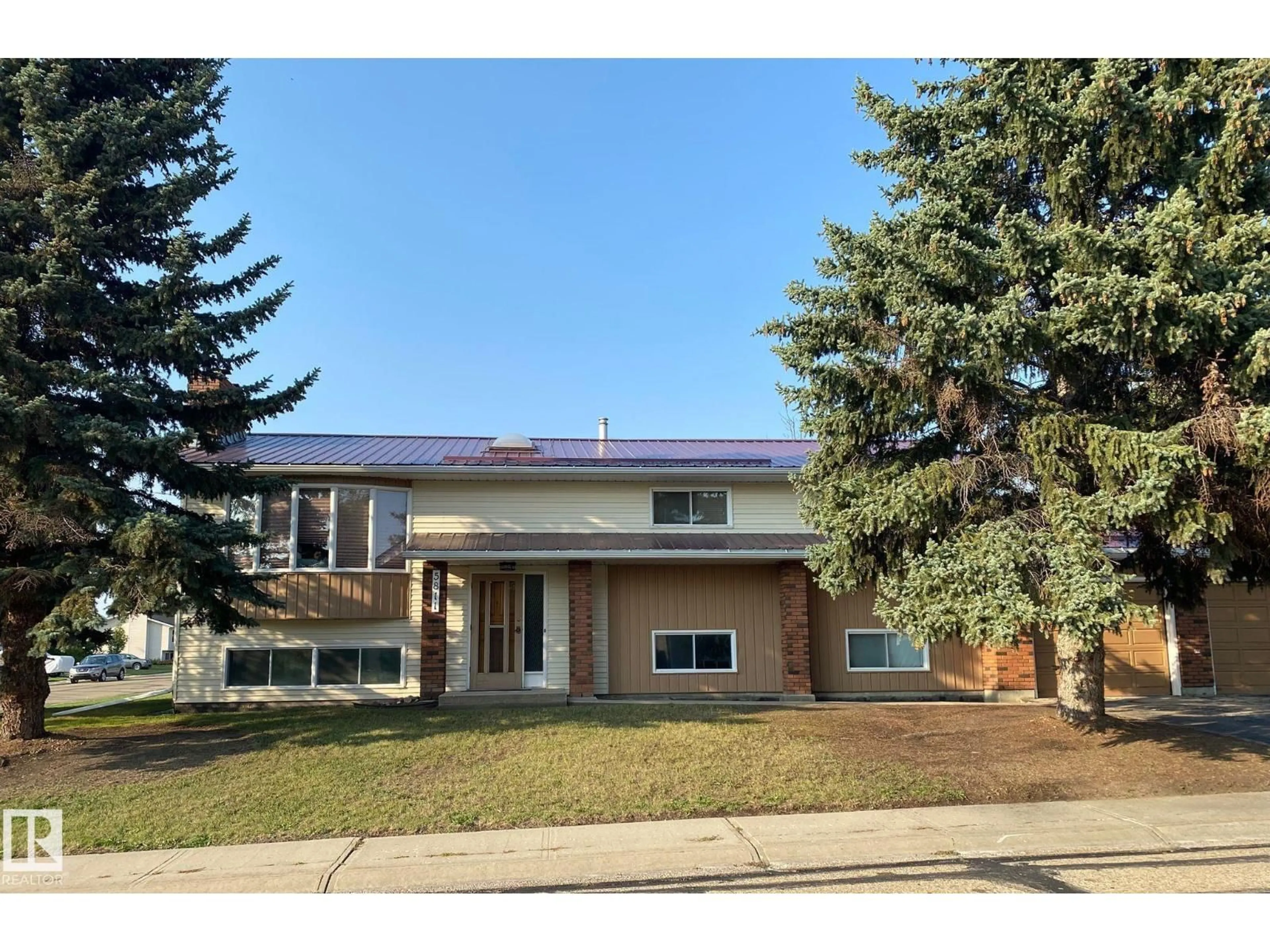 Home with vinyl exterior material, street for 5811 56 ST, Barrhead Alberta T7N1C8