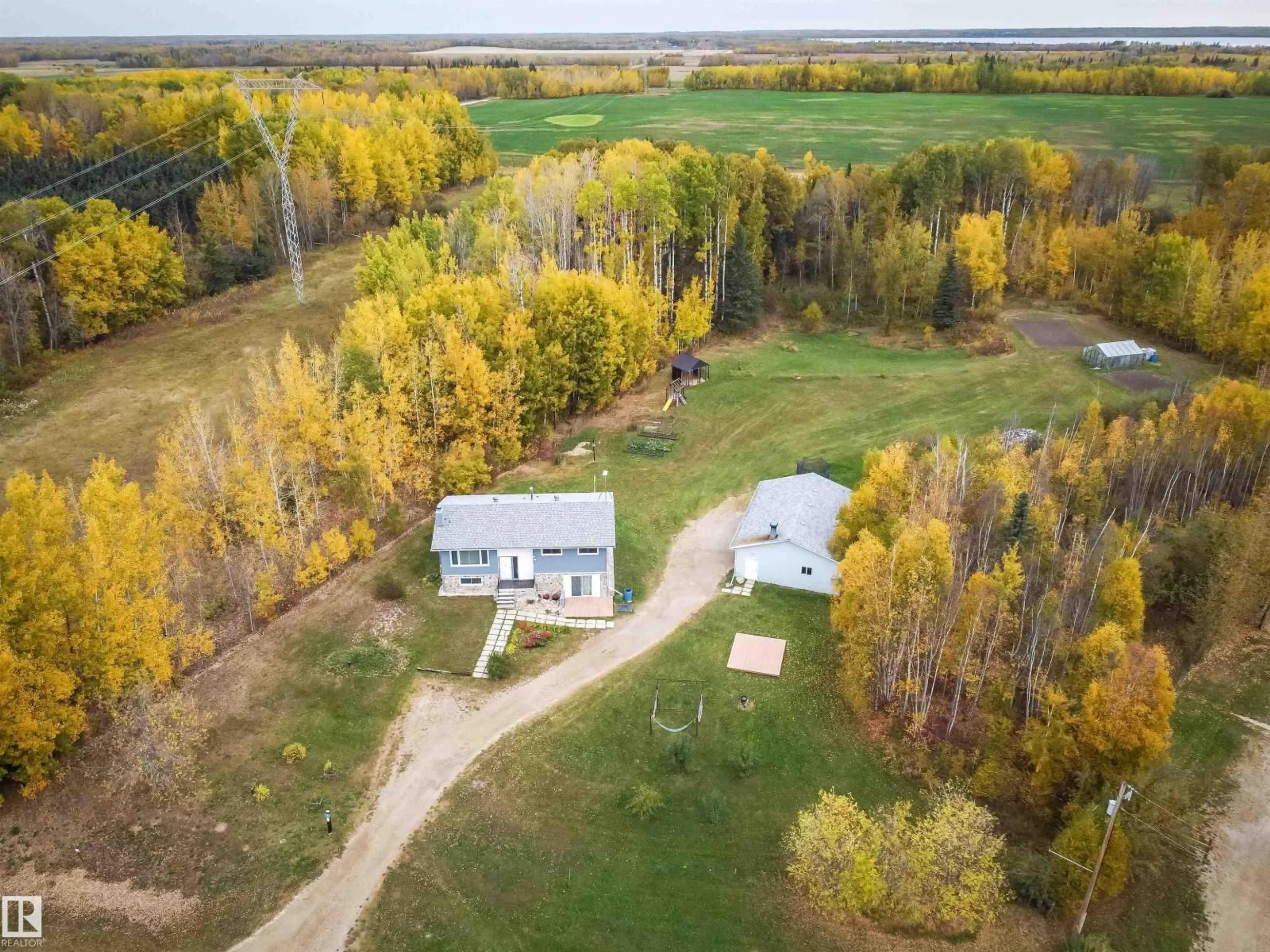 A pic from outside/outdoor area/front of a property/back of a property/a pic from drone, forest/trees view for #4 - 54227 RGE ROAD 41, Rural Lac Ste. Anne County Alberta T0E0A1