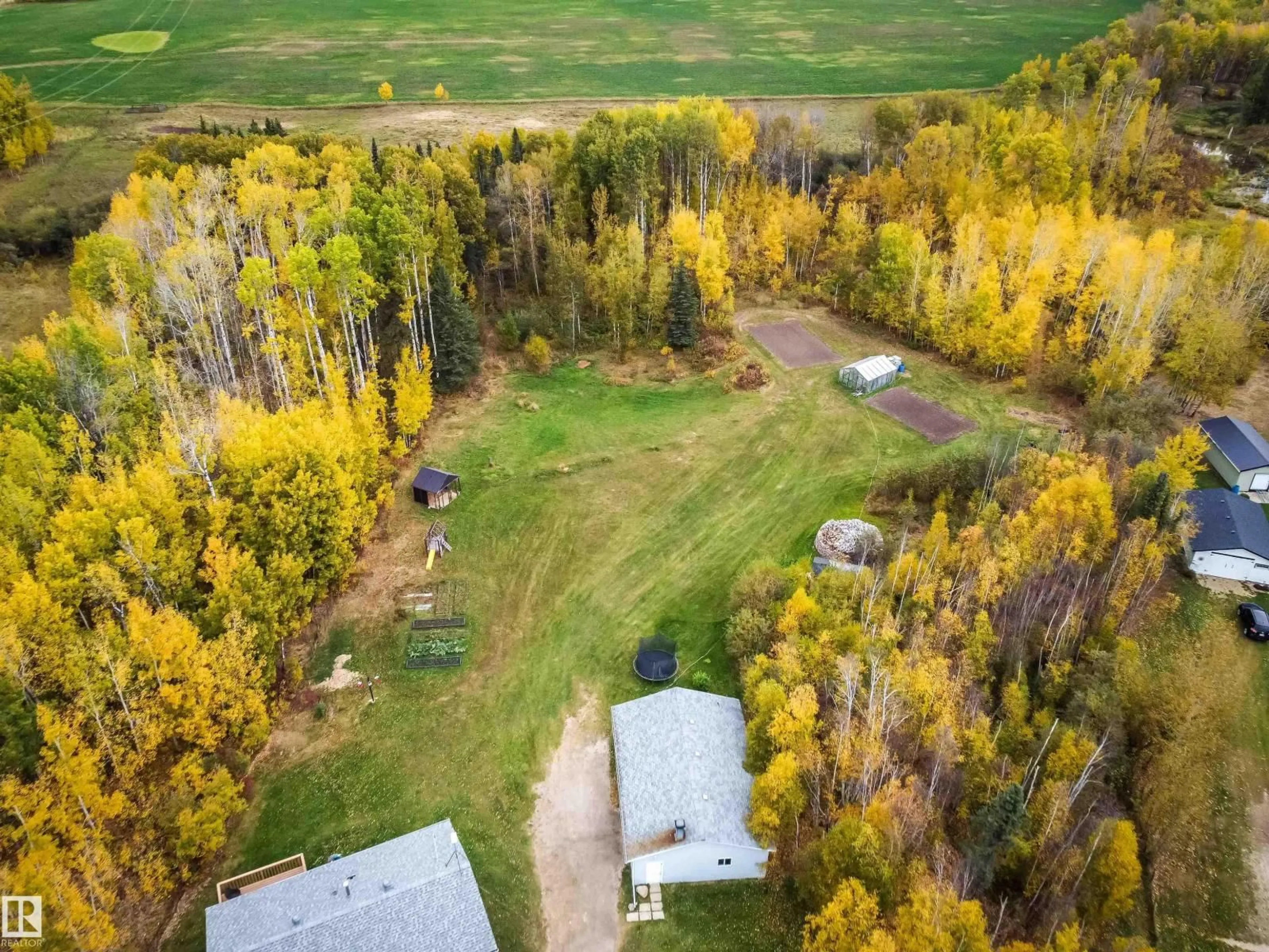 A pic from outside/outdoor area/front of a property/back of a property/a pic from drone, forest/trees view for #4 - 54227 RGE ROAD 41, Rural Lac Ste. Anne County Alberta T0E0A1