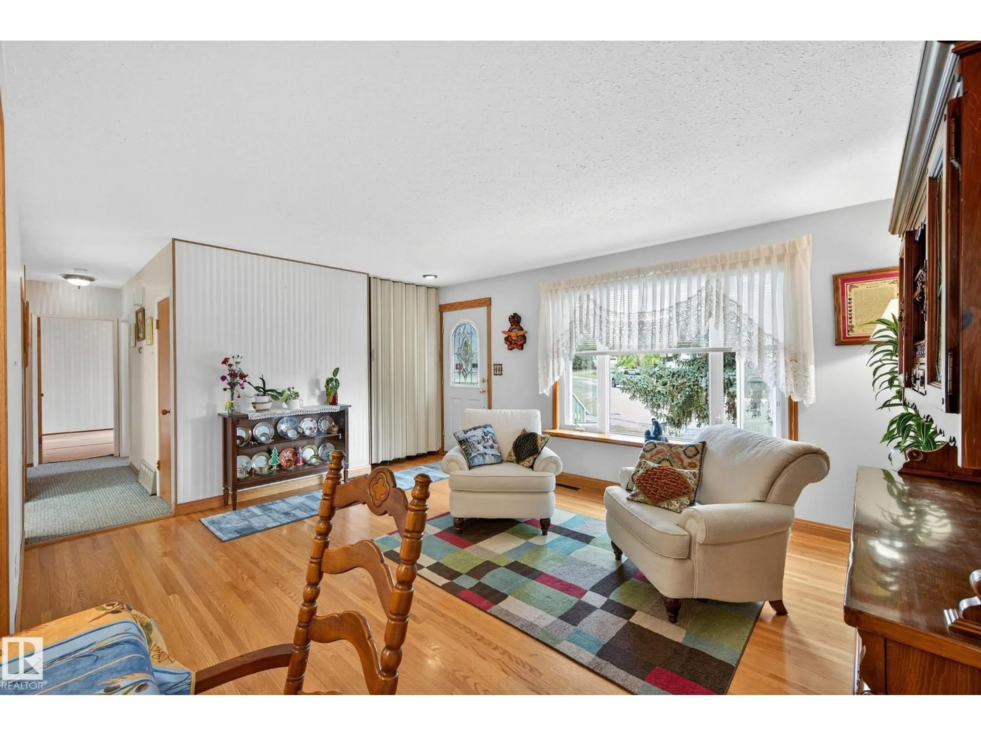 Living room with furniture, wood/laminate floor for 10527 133 AV, Edmonton Alberta T5E1E2