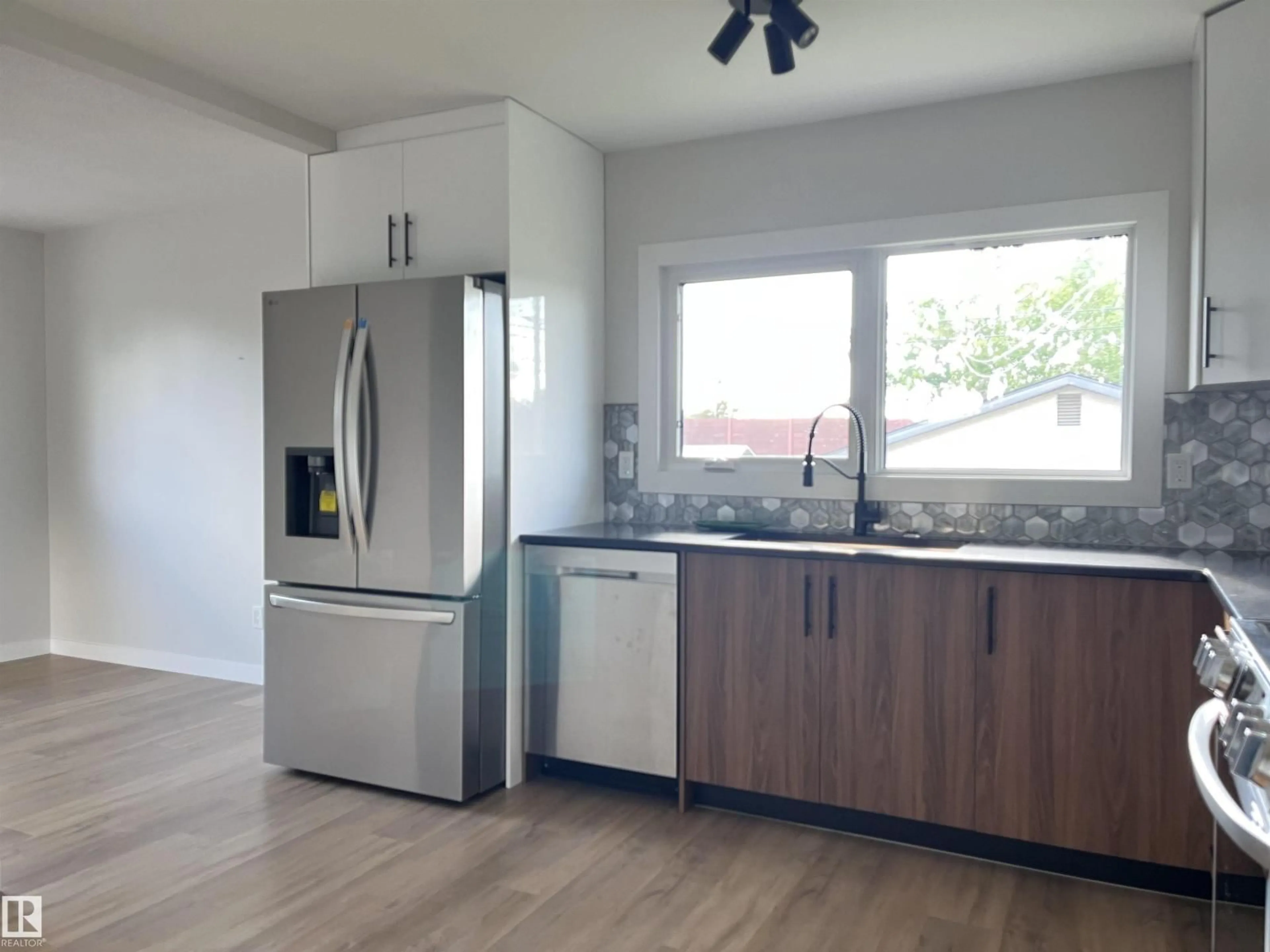 Open concept kitchen, wood/laminate floor for 9108 169 ST, Edmonton Alberta T5R2X1