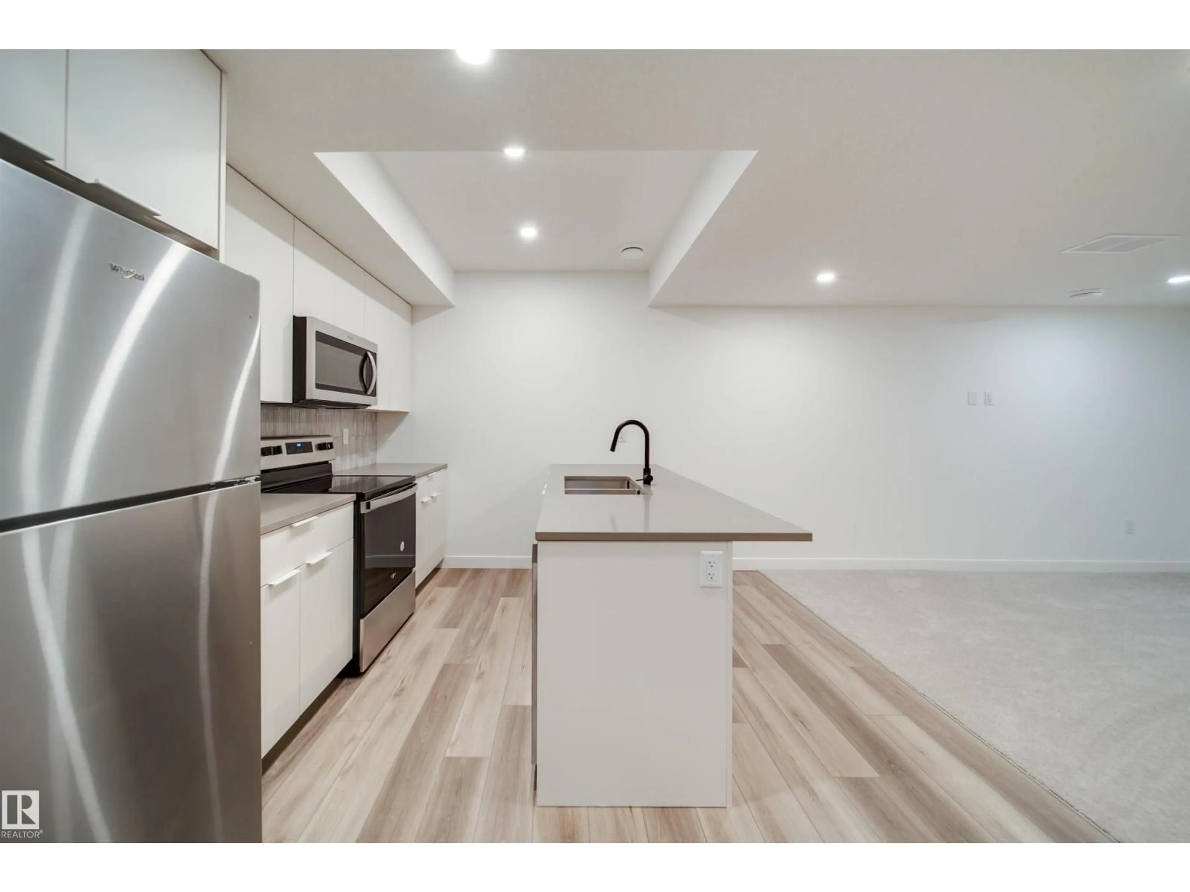 Open concept kitchen, wood/laminate floor for 8522 80 AV, Edmonton Alberta T6C0W3