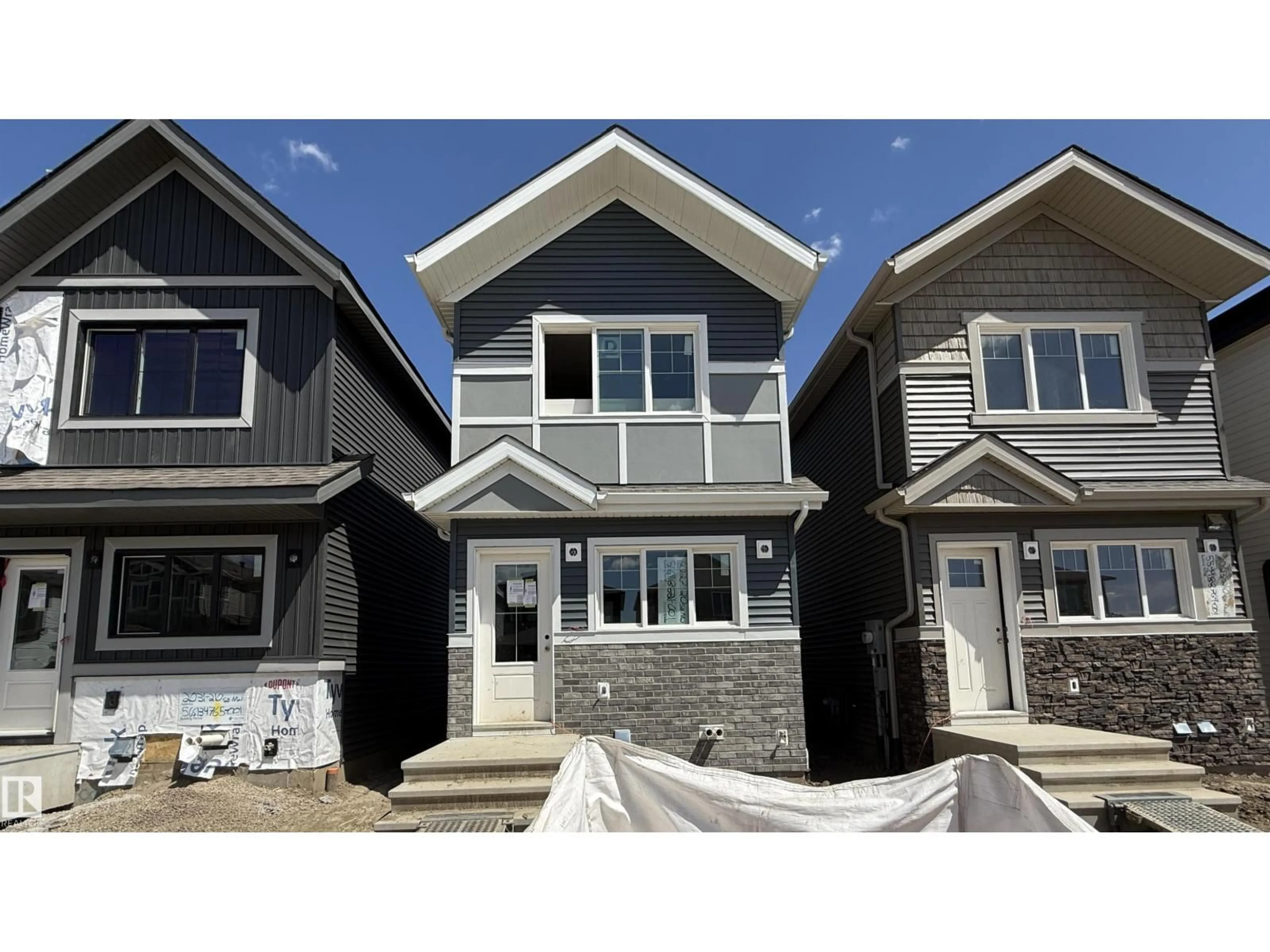 Home with vinyl exterior material, street for NW - 2027 210 ST, Edmonton Alberta T6M2P5