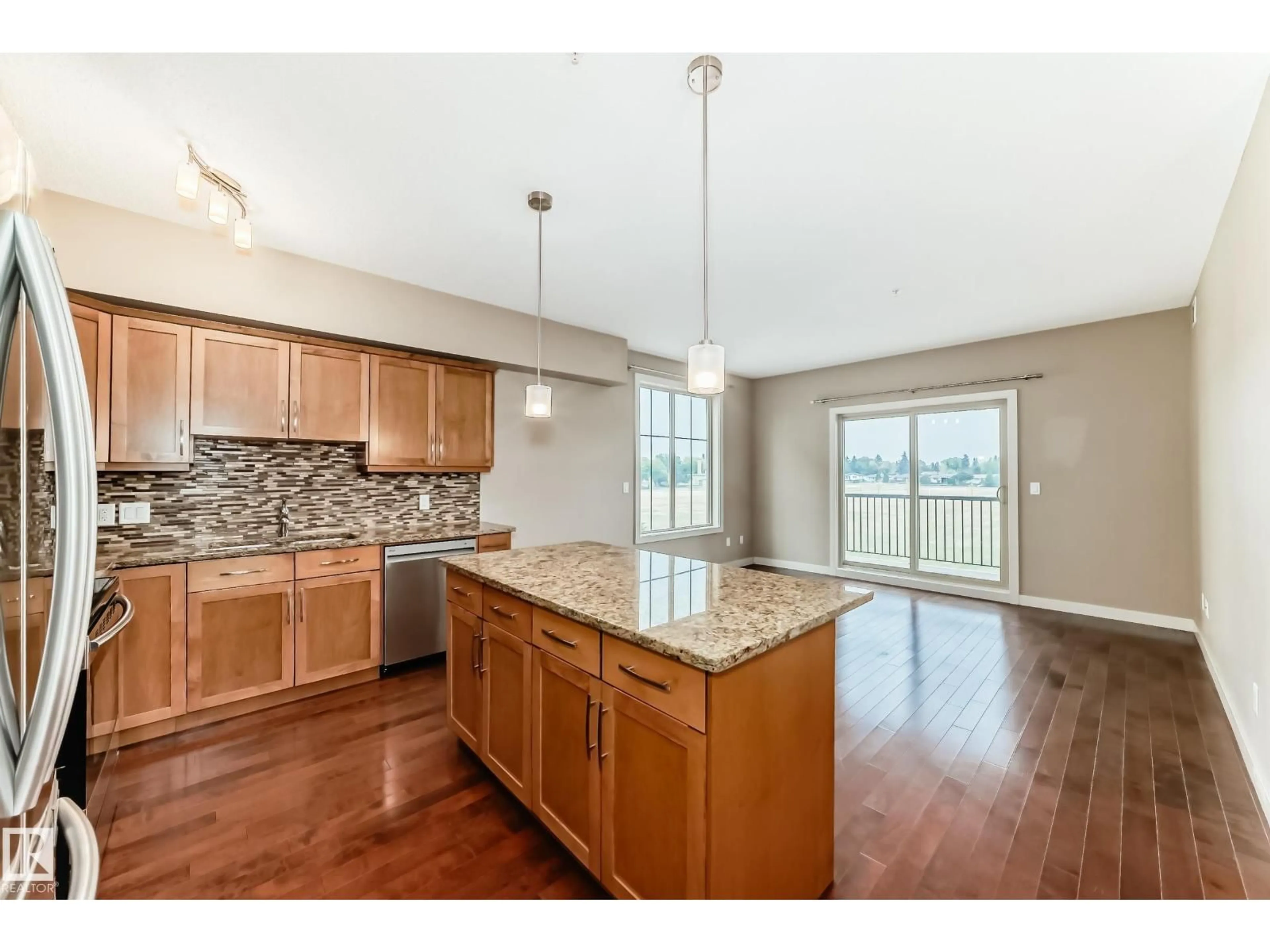 Open concept kitchen, wood/laminate floor for 203 - 10520 56 AV, Edmonton Alberta T6H0X7