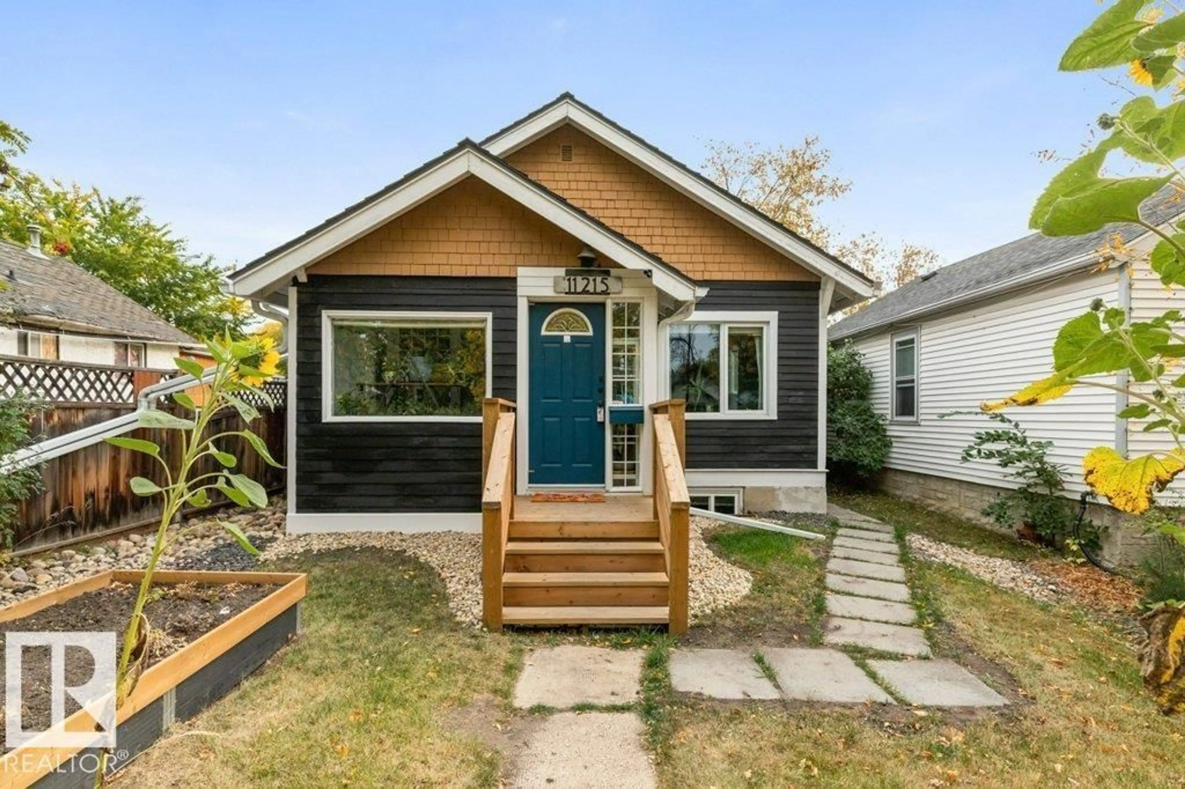 Home with vinyl exterior material, street for NW - 11215 67 ST, Edmonton Alberta T5B1K9