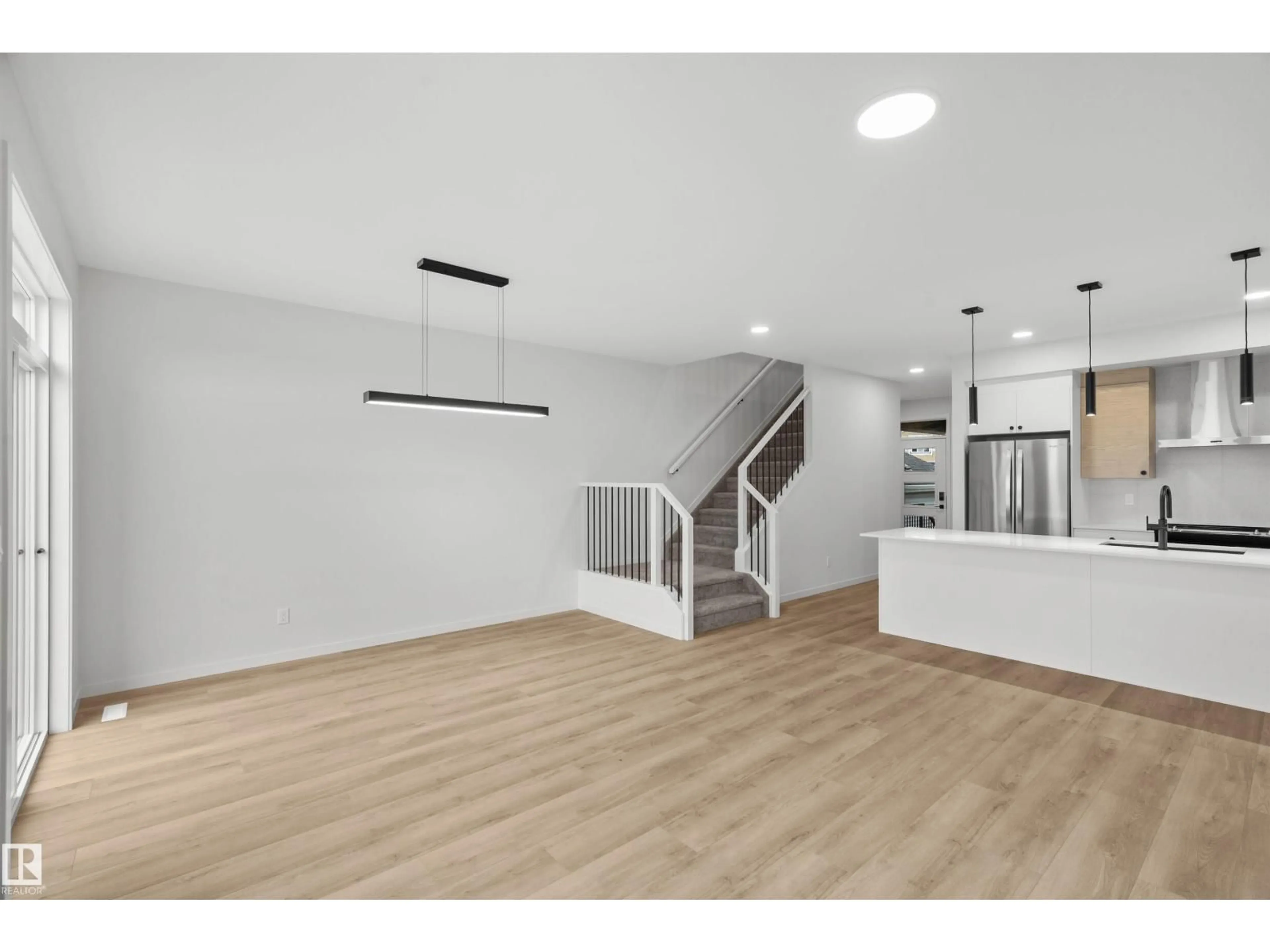 Open concept kitchen, wood/laminate floor for 22931 80 AVENUE AVENUE, Edmonton Alberta T5T7Y1