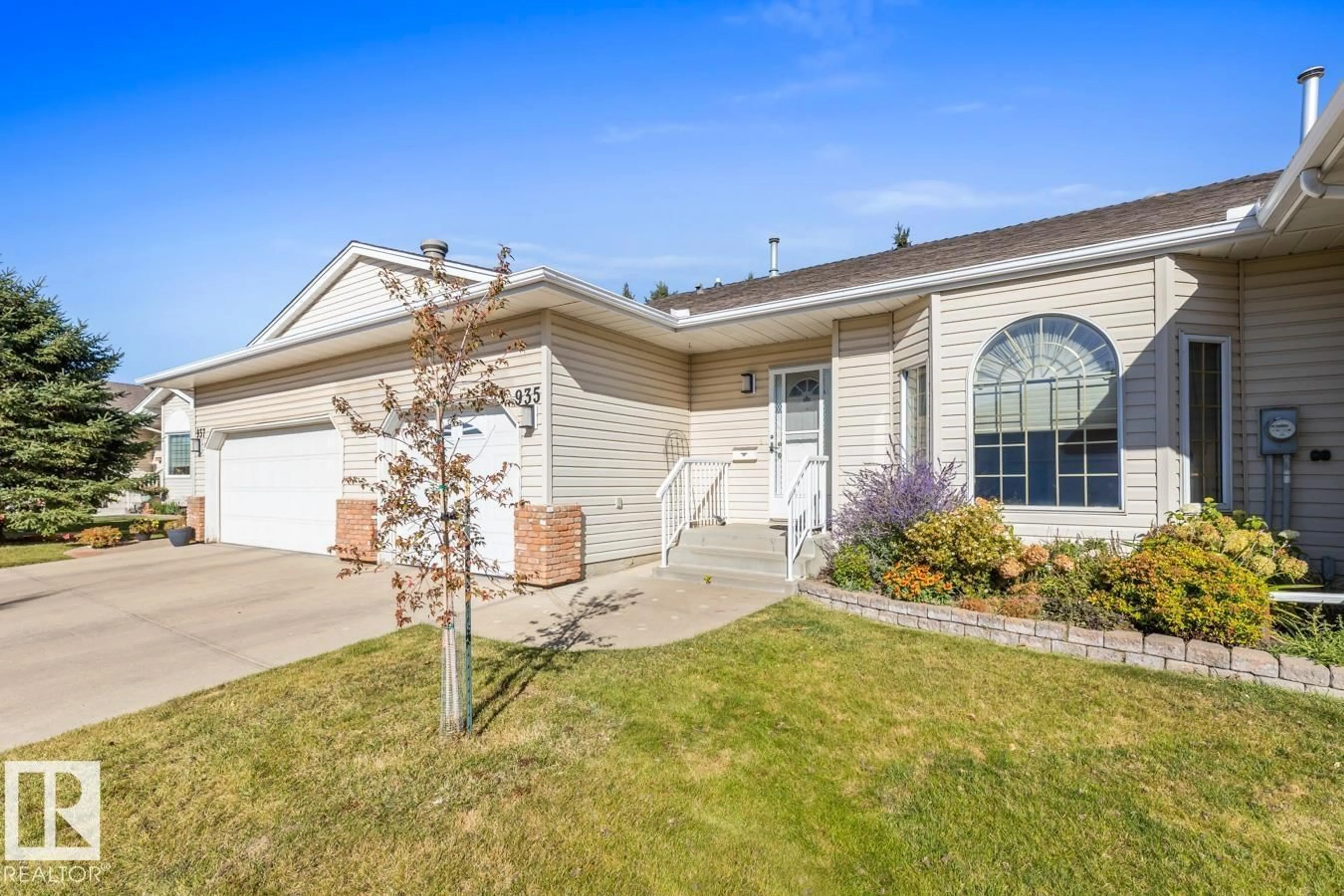 Home with vinyl exterior material, street for 935 YOUVILLE DR, Edmonton Alberta T6L6T2