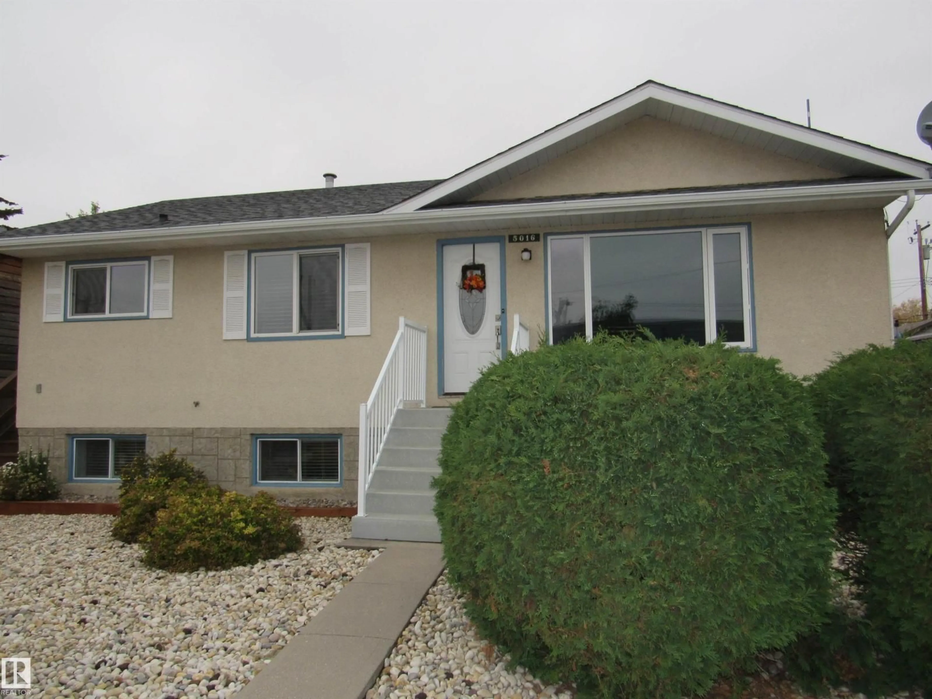 Home with vinyl exterior material, street for 5016 51 ST, Barrhead Alberta T7N1A1