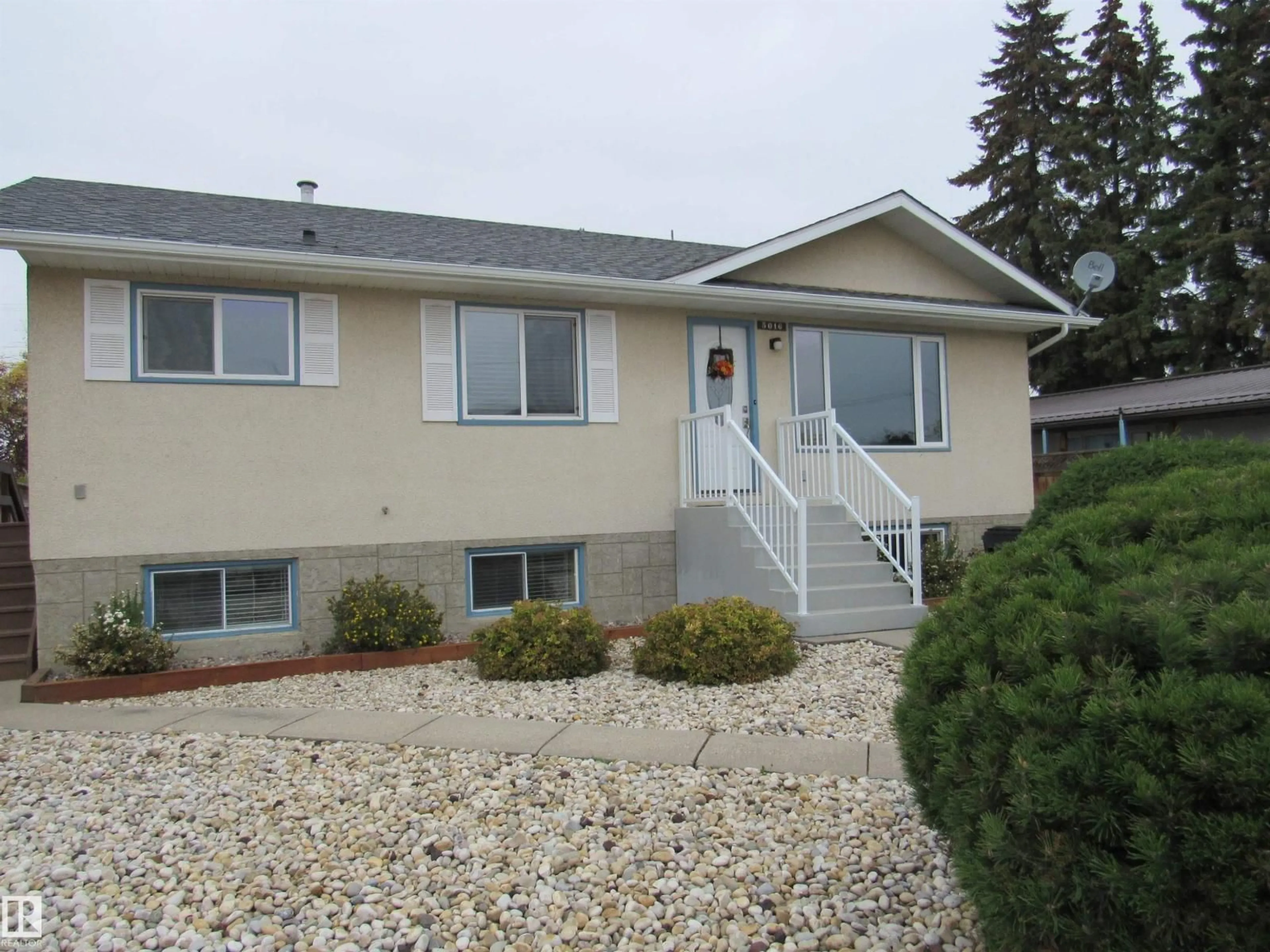 Home with vinyl exterior material, street for 5016 51 ST, Barrhead Alberta T7N1A1