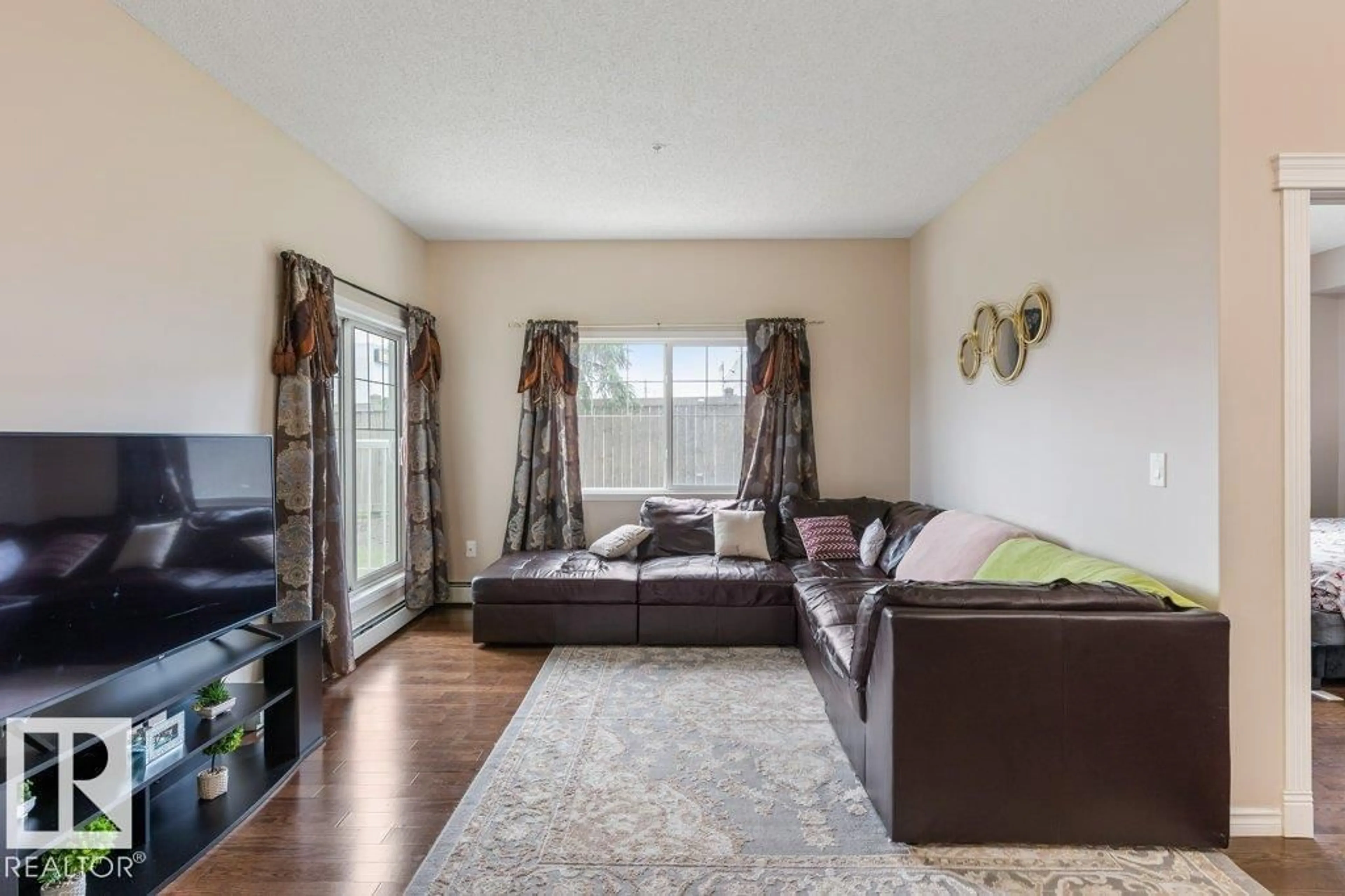 Living room with furniture, wood/laminate floor for #135 - 16807 100 AV, Edmonton Alberta T5P4Z6