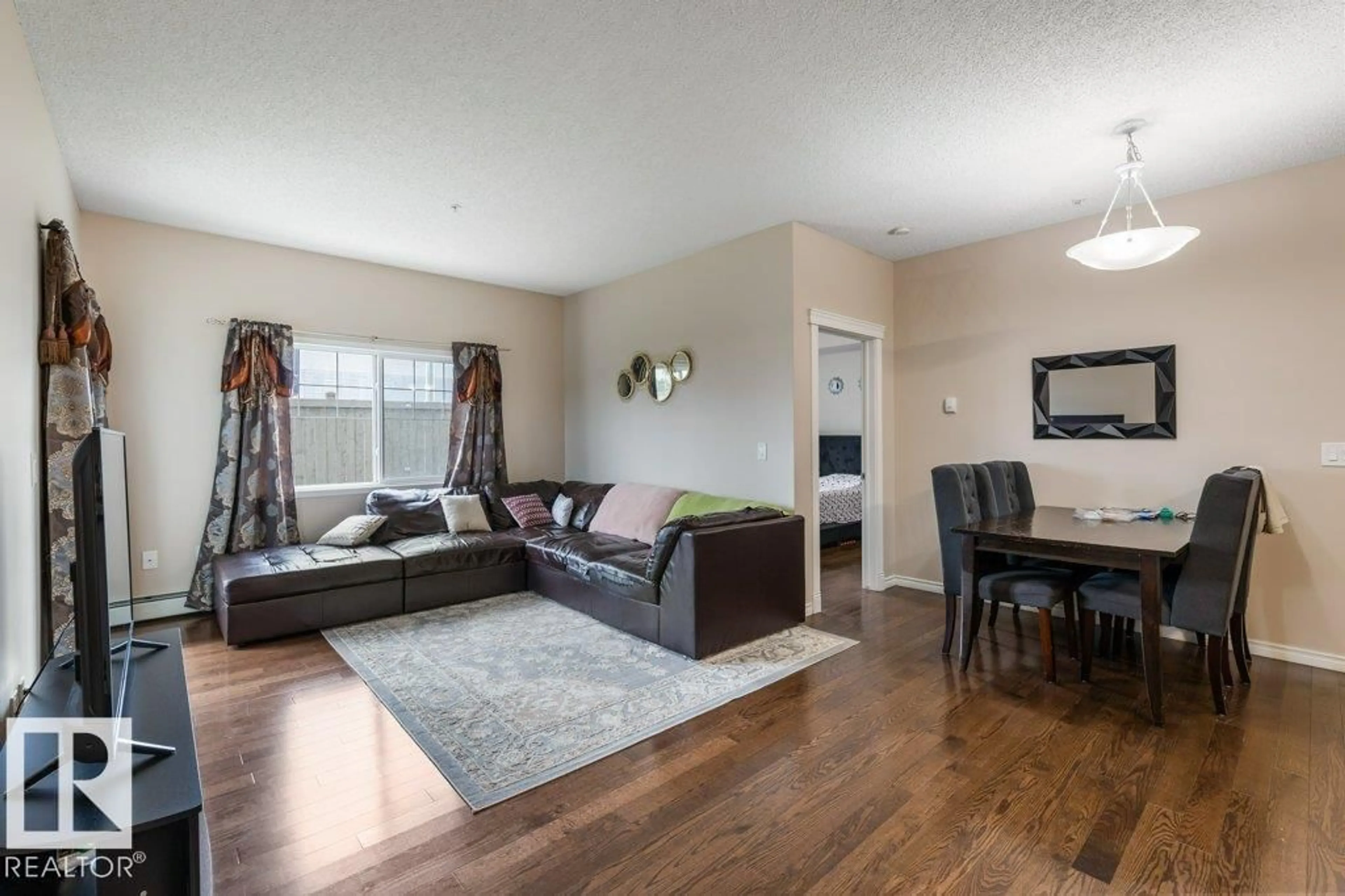 Living room with furniture, wood/laminate floor for #135 - 16807 100 AV, Edmonton Alberta T5P4Z6