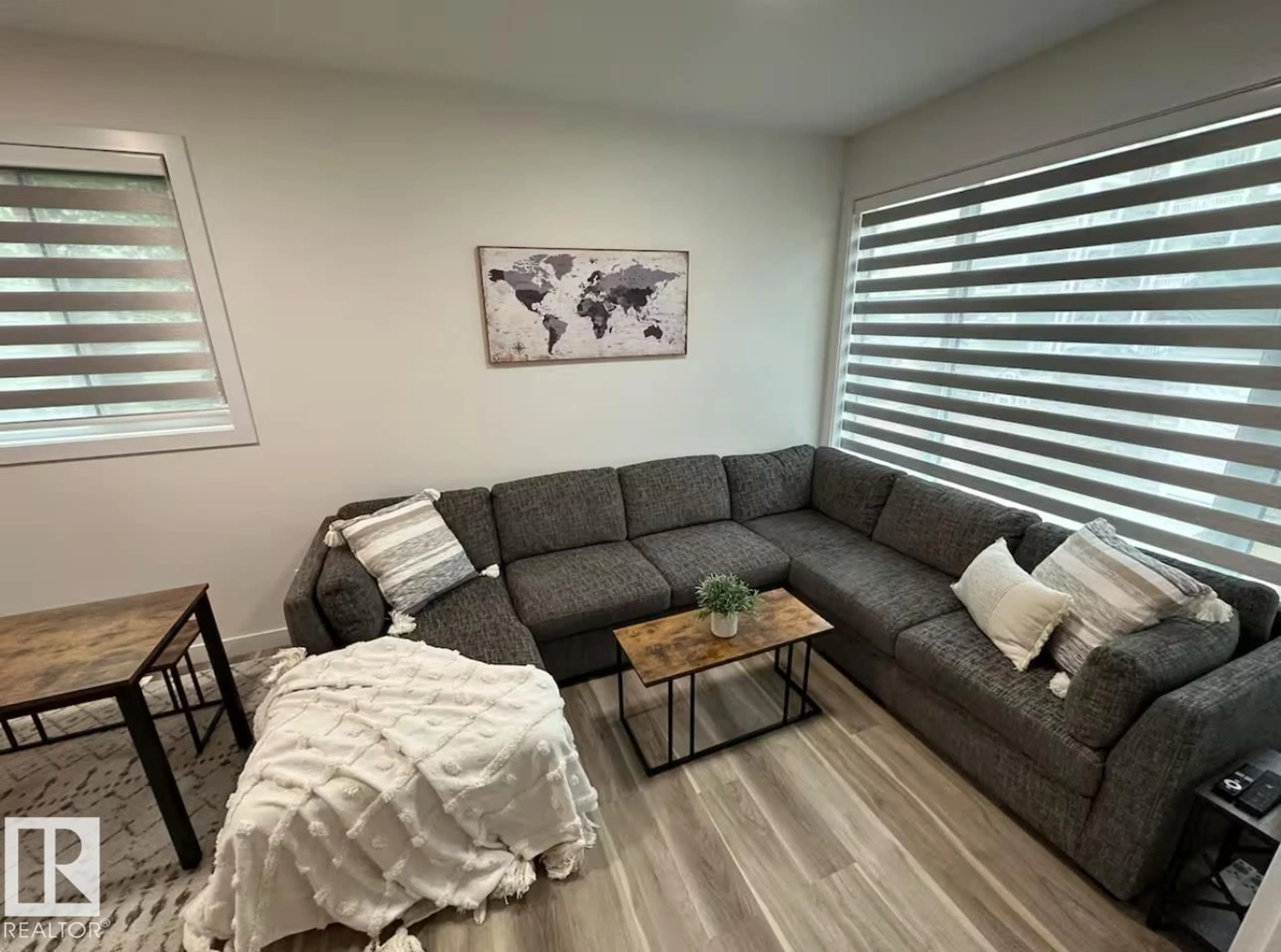 Living room with furniture, wood/laminate floor for 11315 95A ST NW, Edmonton Alberta T5G1P2
