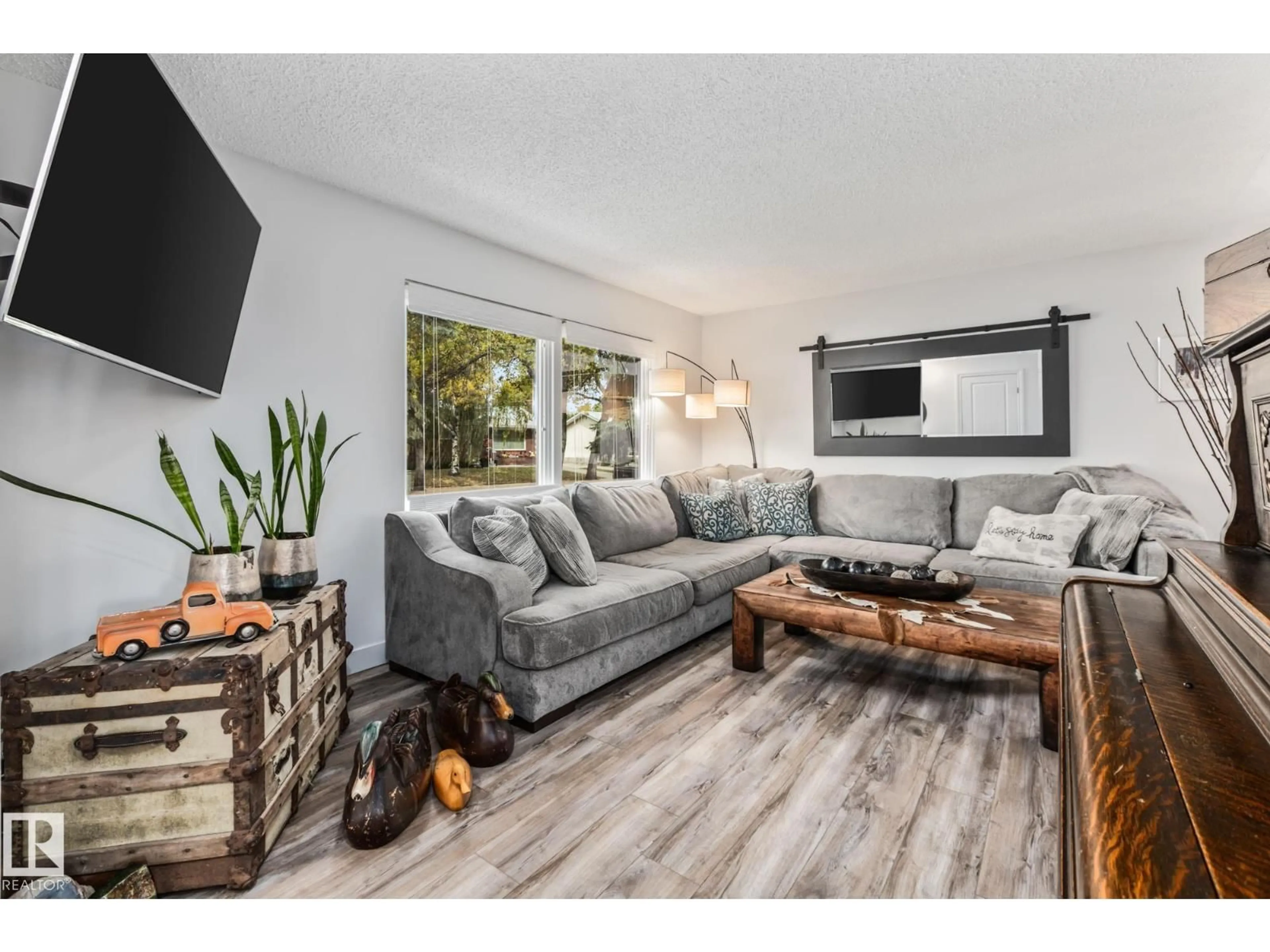 Living room with furniture, wood/laminate floor for 17 LAURIER CR, St. Albert Alberta T8N1M6