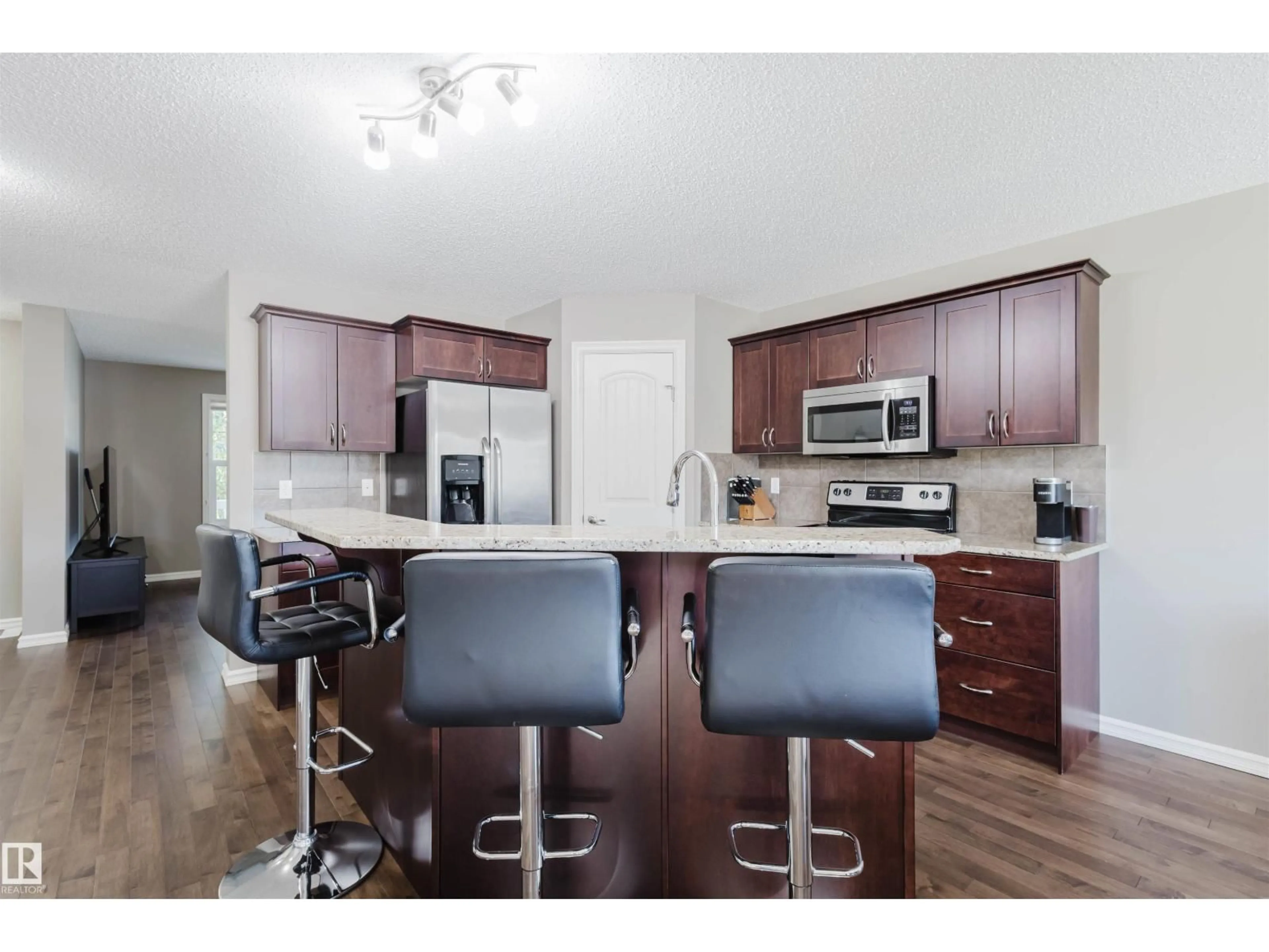 Open concept kitchen, wood/laminate floor for NW - 9428 212 ST, Edmonton Alberta T5T4R3