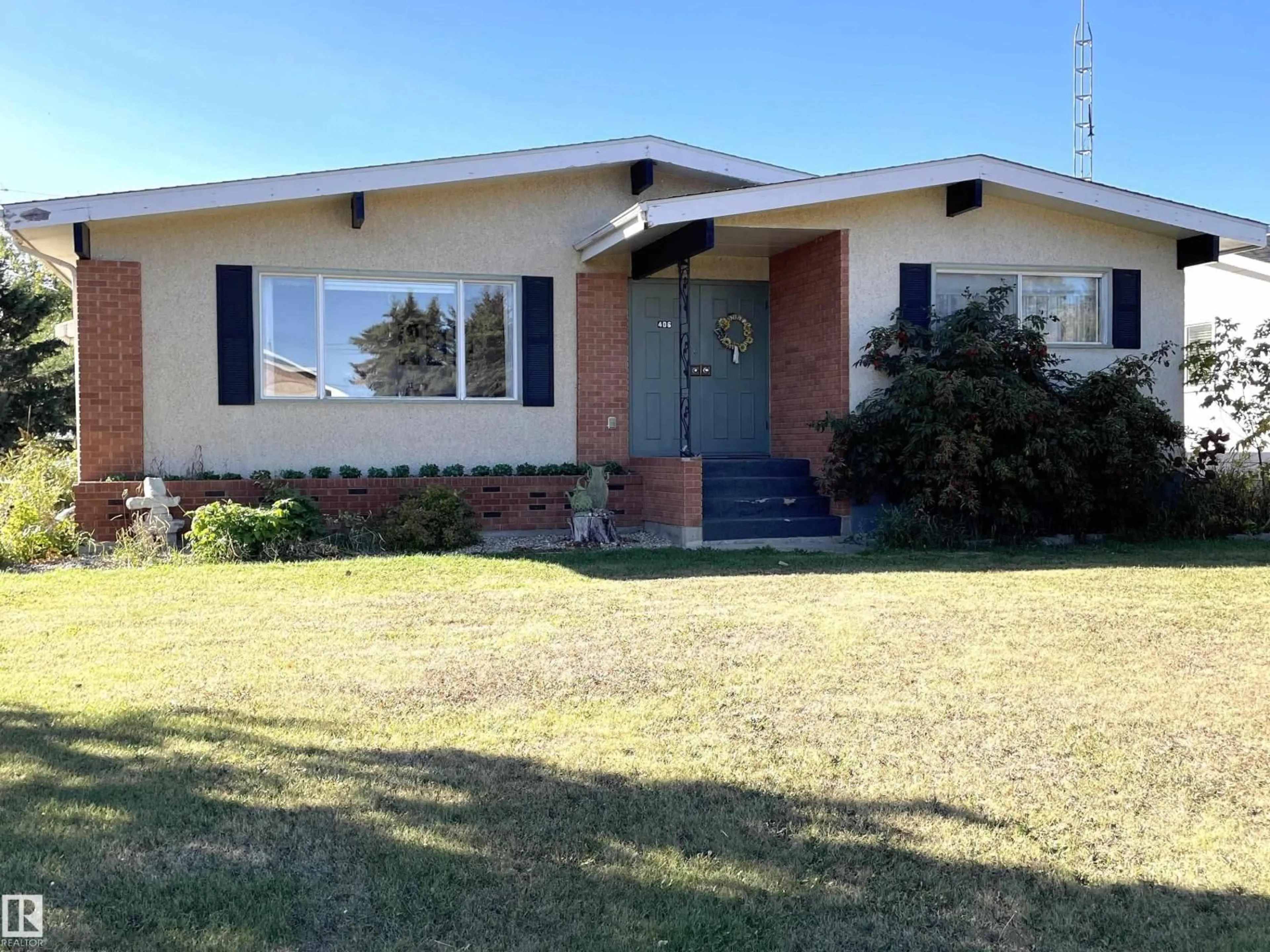 Home with brick exterior material, street for 406 6 ST, Thorhild Alberta T0A3J0