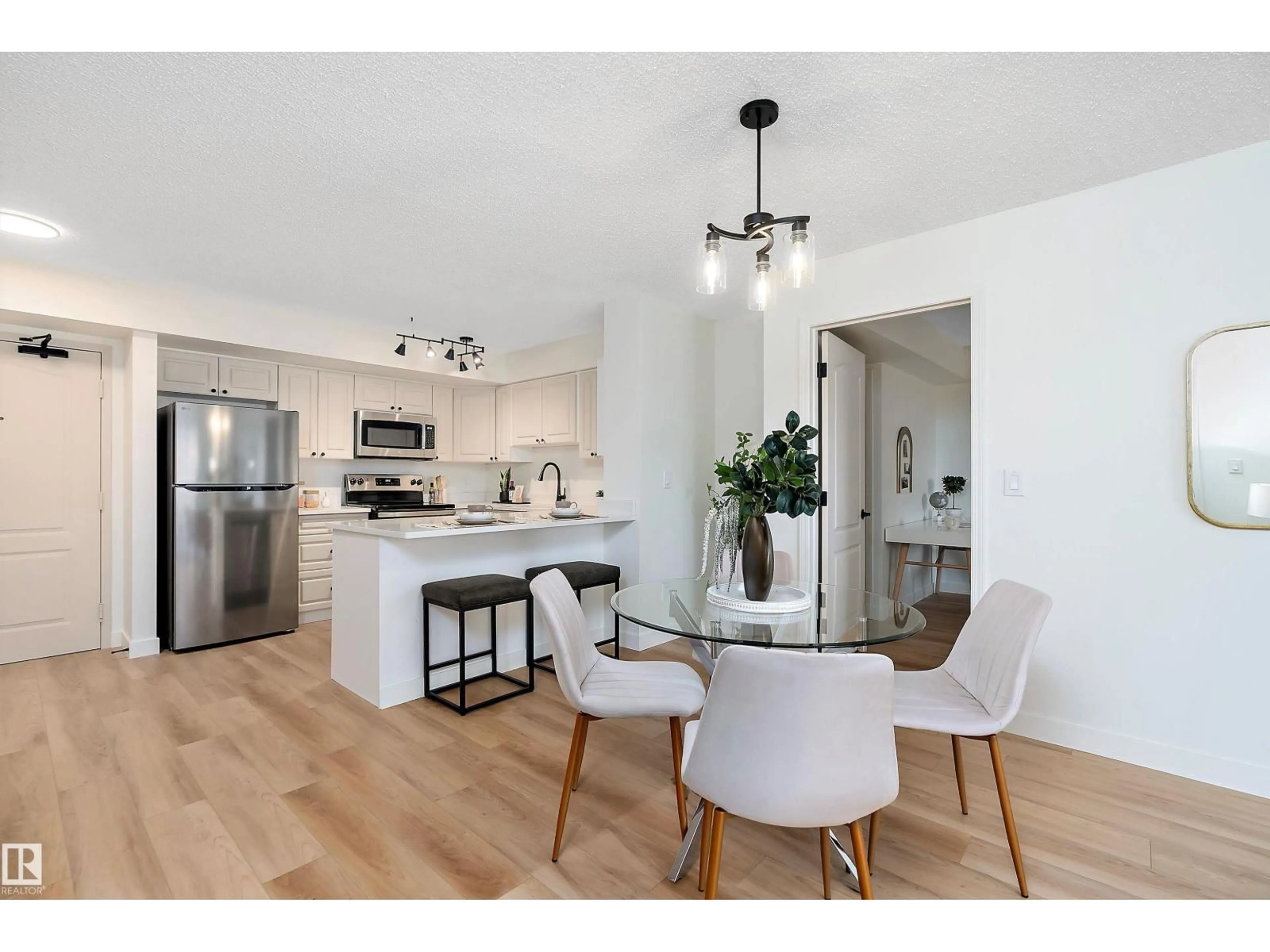Open concept kitchen, wood/laminate floor for 10909 103 AV, Edmonton Alberta T5K2W7