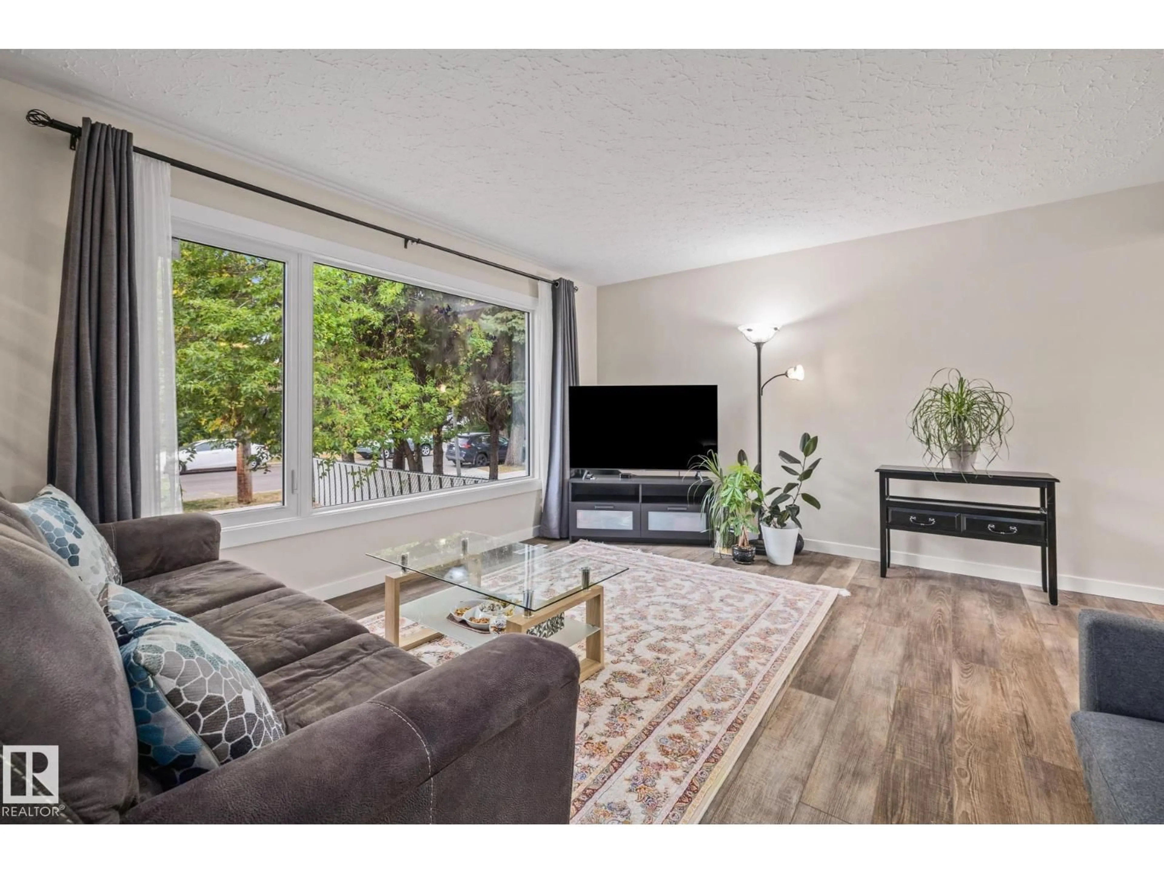 Living room with furniture, wood/laminate floor for 10820 60 AV, Edmonton Alberta T6H4R1