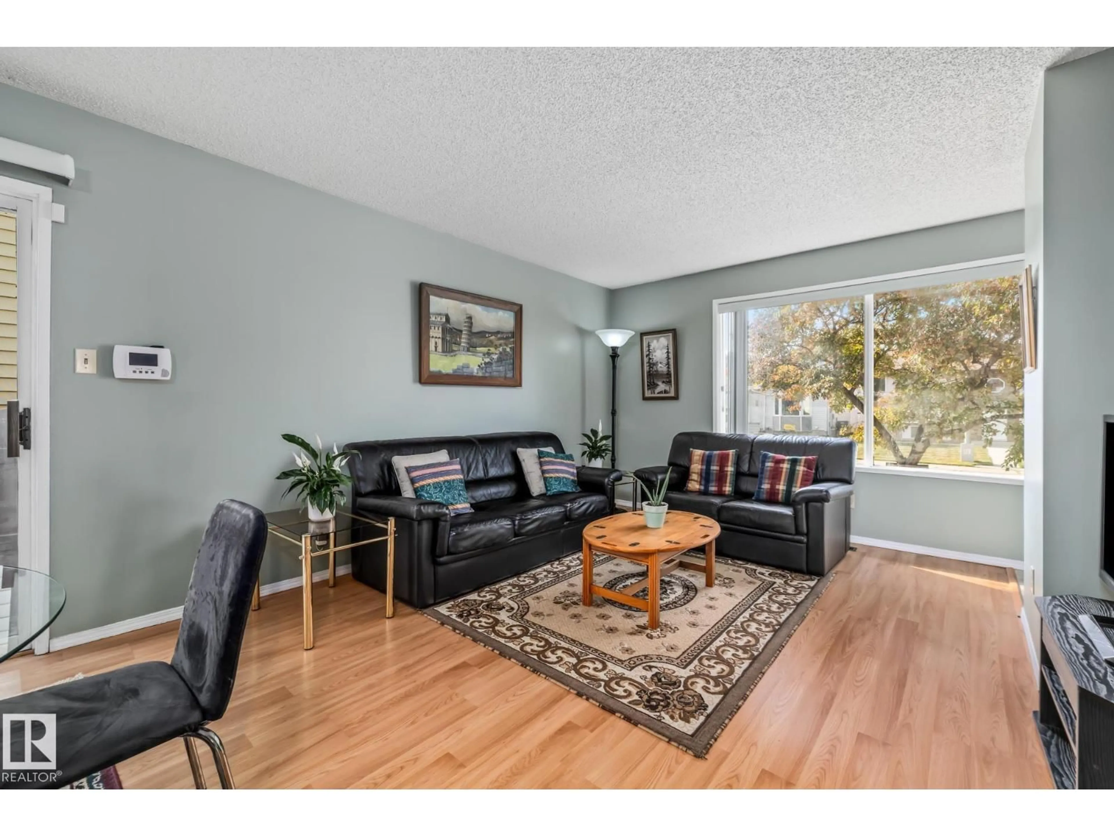 Living room with furniture, wood/laminate floor for NW - 7327 189 ST, Edmonton Alberta T5T5G7