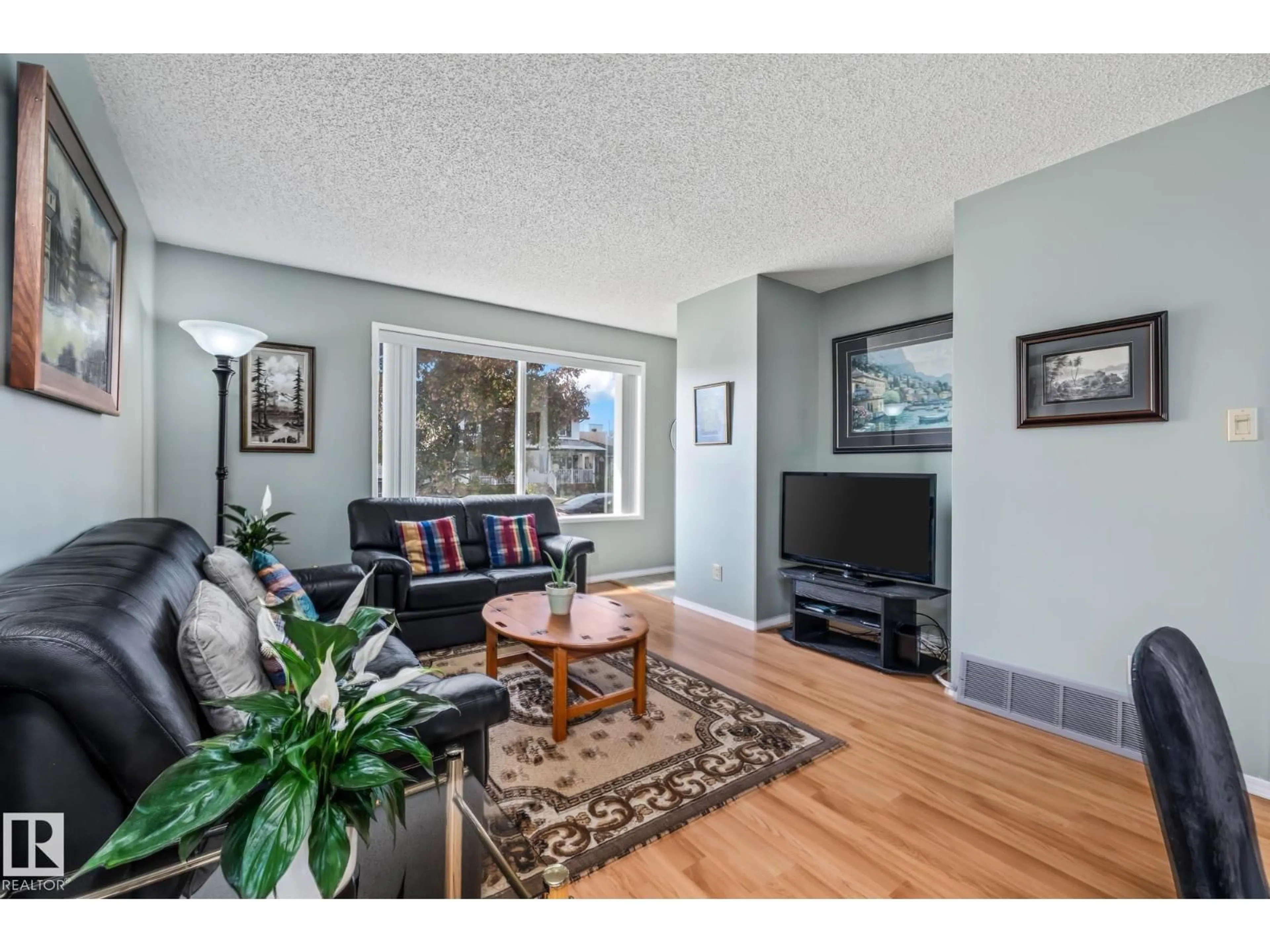 Living room with furniture, wood/laminate floor for NW - 7327 189 ST, Edmonton Alberta T5T5G7