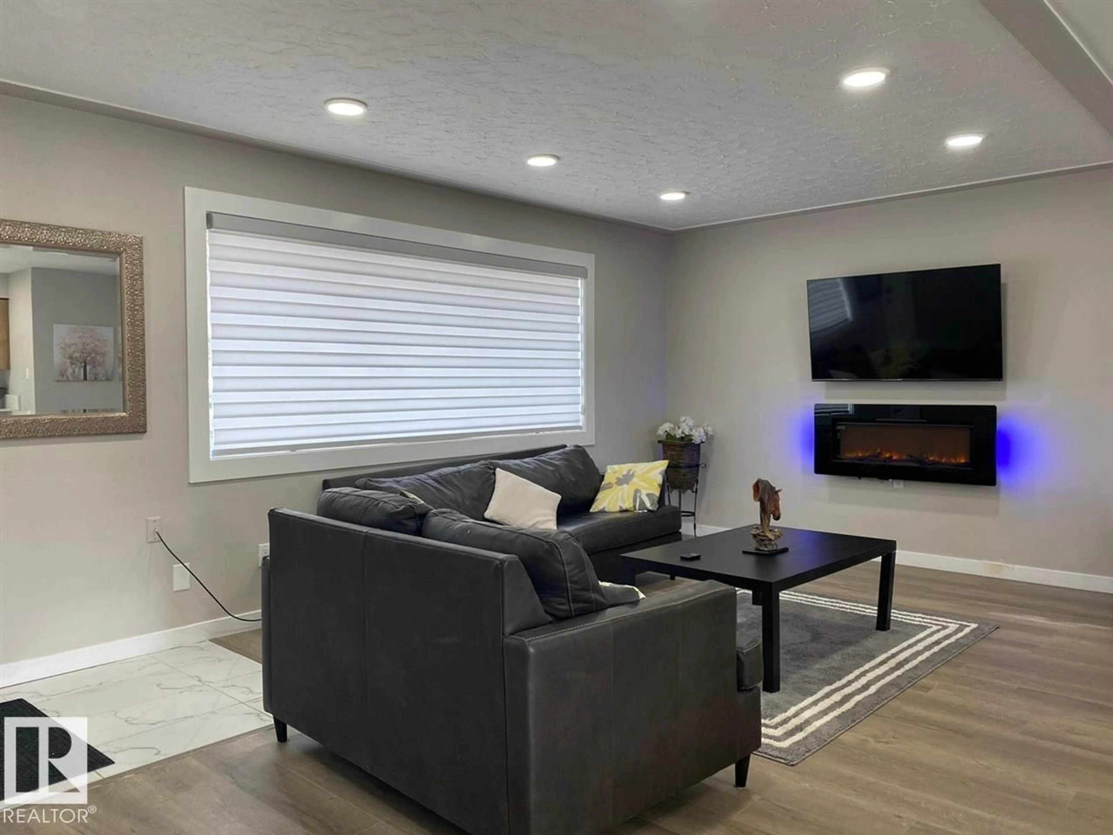 Living room with furniture, wood/laminate floor for NW - 7303 90 AV, Edmonton Alberta T6B0P6