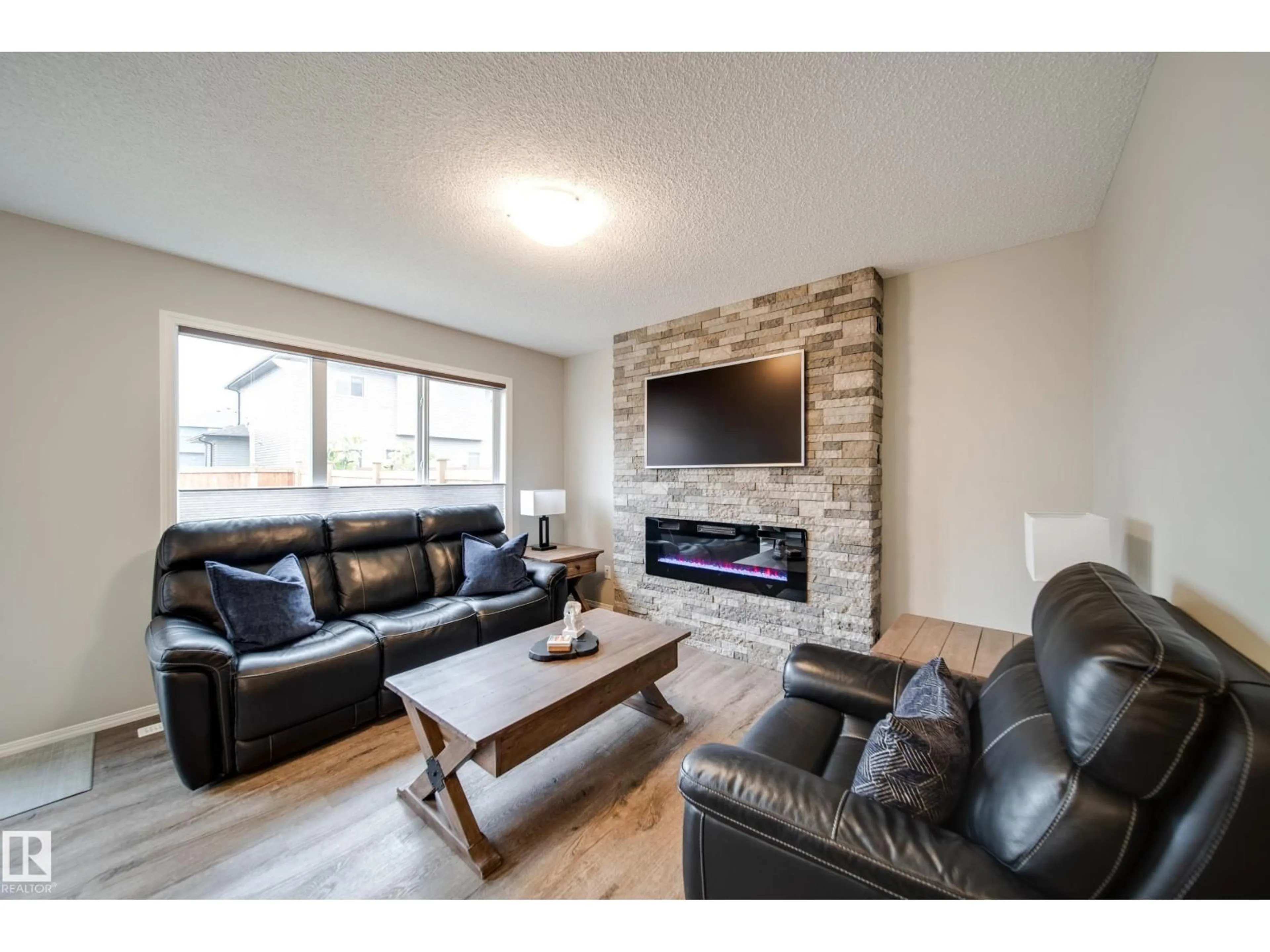 Living room with furniture, wood/laminate floor for SW - 9040 COOPER LINK LI, Edmonton Alberta T6W4A4