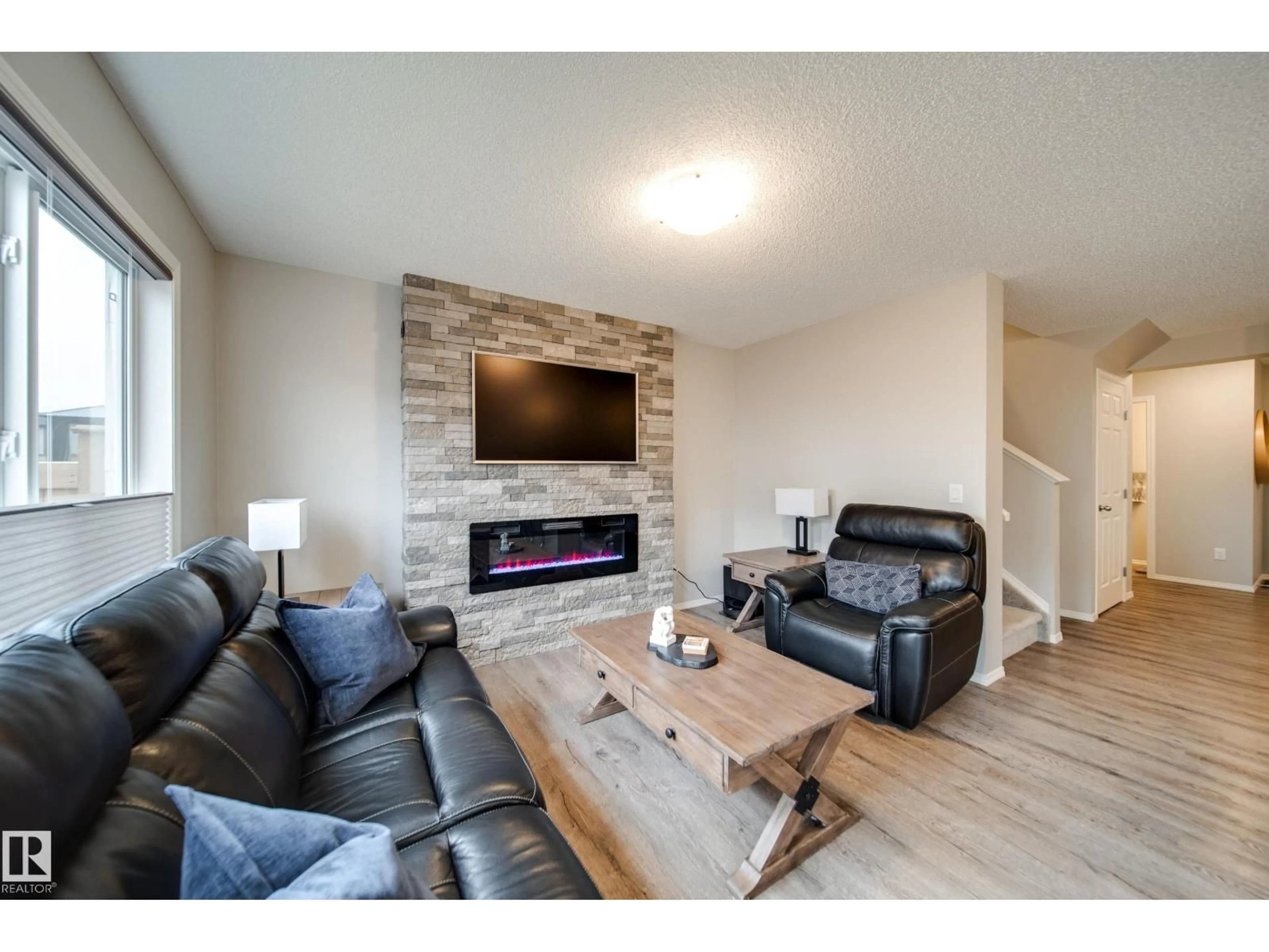 Living room with furniture, wood/laminate floor for SW - 9040 COOPER LINK LI, Edmonton Alberta T6W4A4