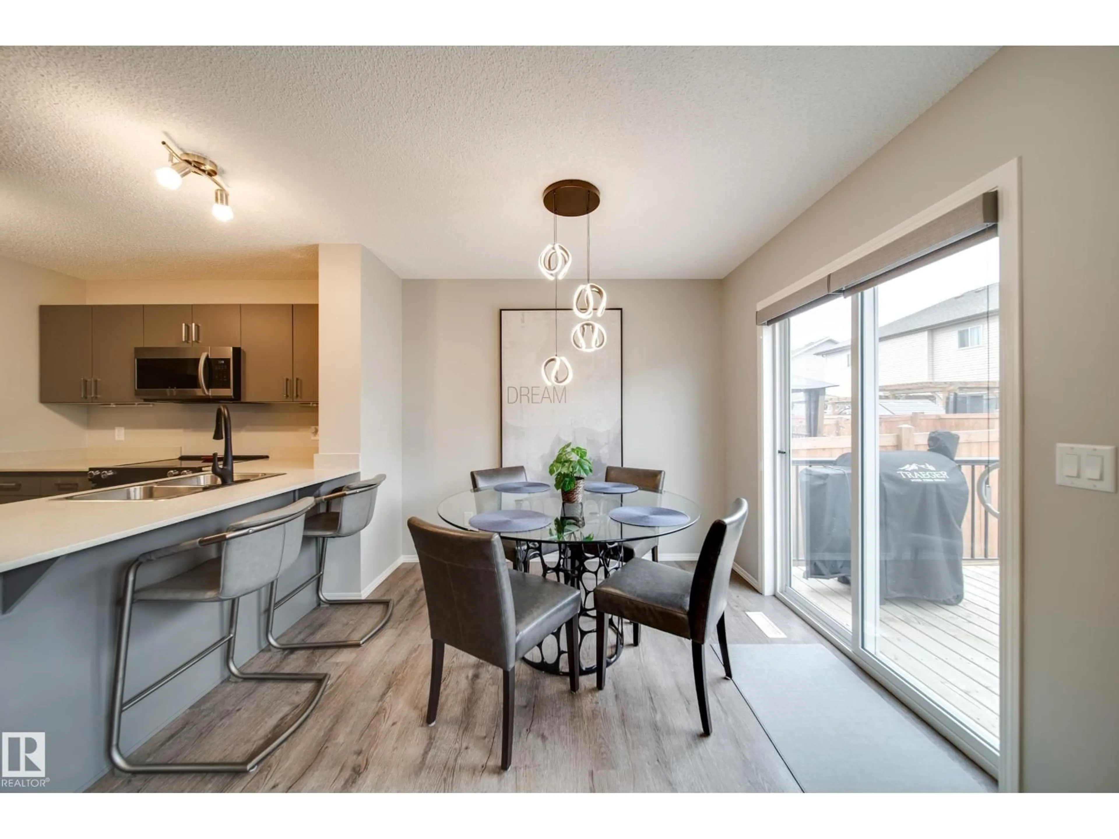 Open concept kitchen, wood/laminate floor for SW - 9040 COOPER LINK LI, Edmonton Alberta T6W4A4