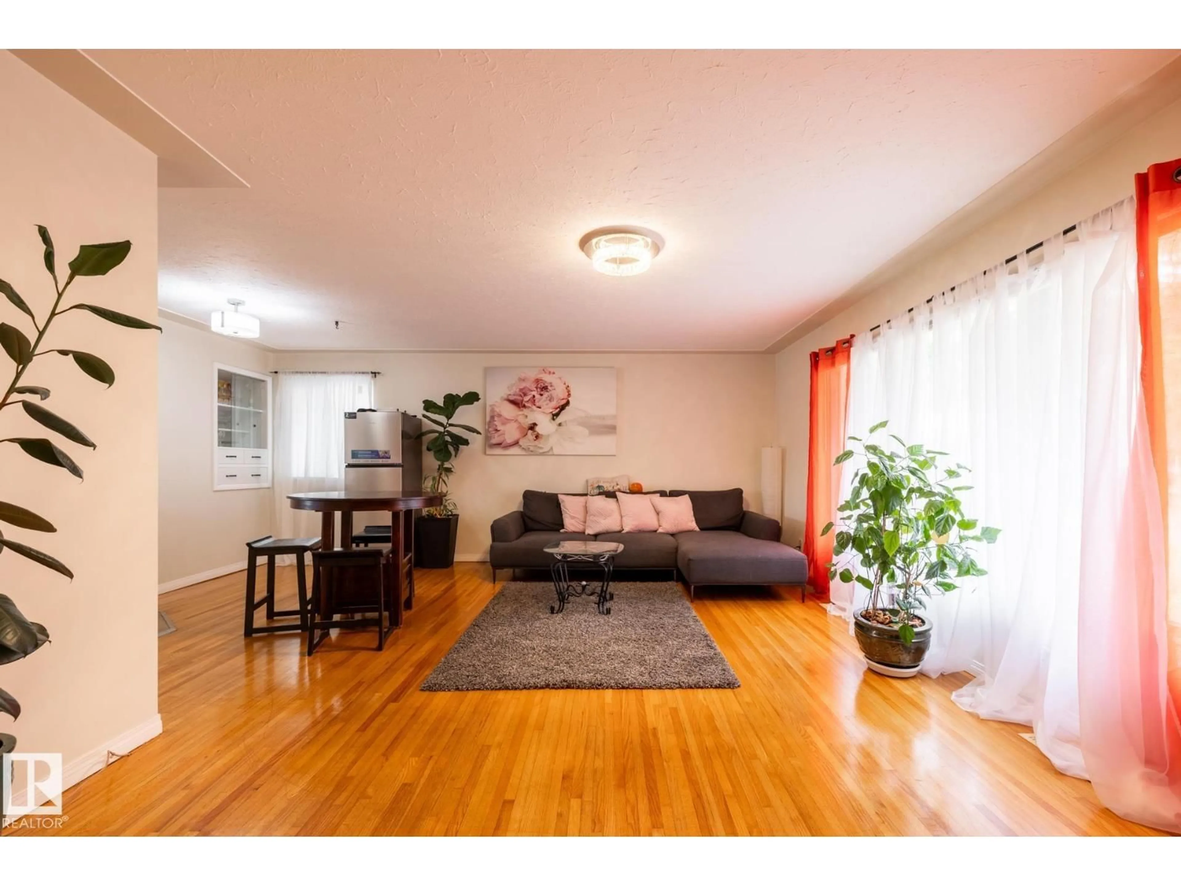 Living room with furniture, wood/laminate floor for 15707 92 AV, Edmonton Alberta T5R5C5