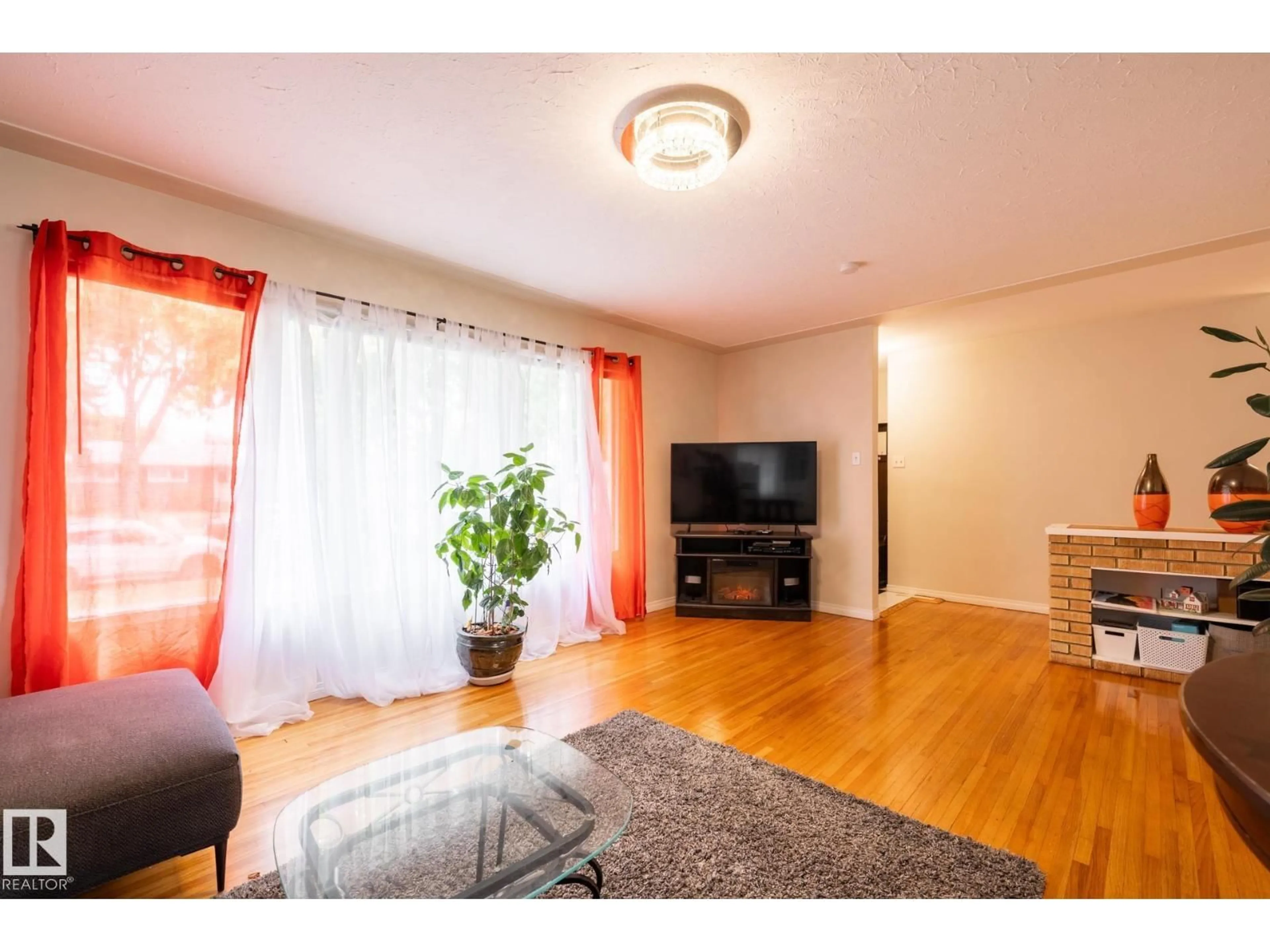 Living room with furniture, wood/laminate floor for 15707 92 AV, Edmonton Alberta T5R5C5