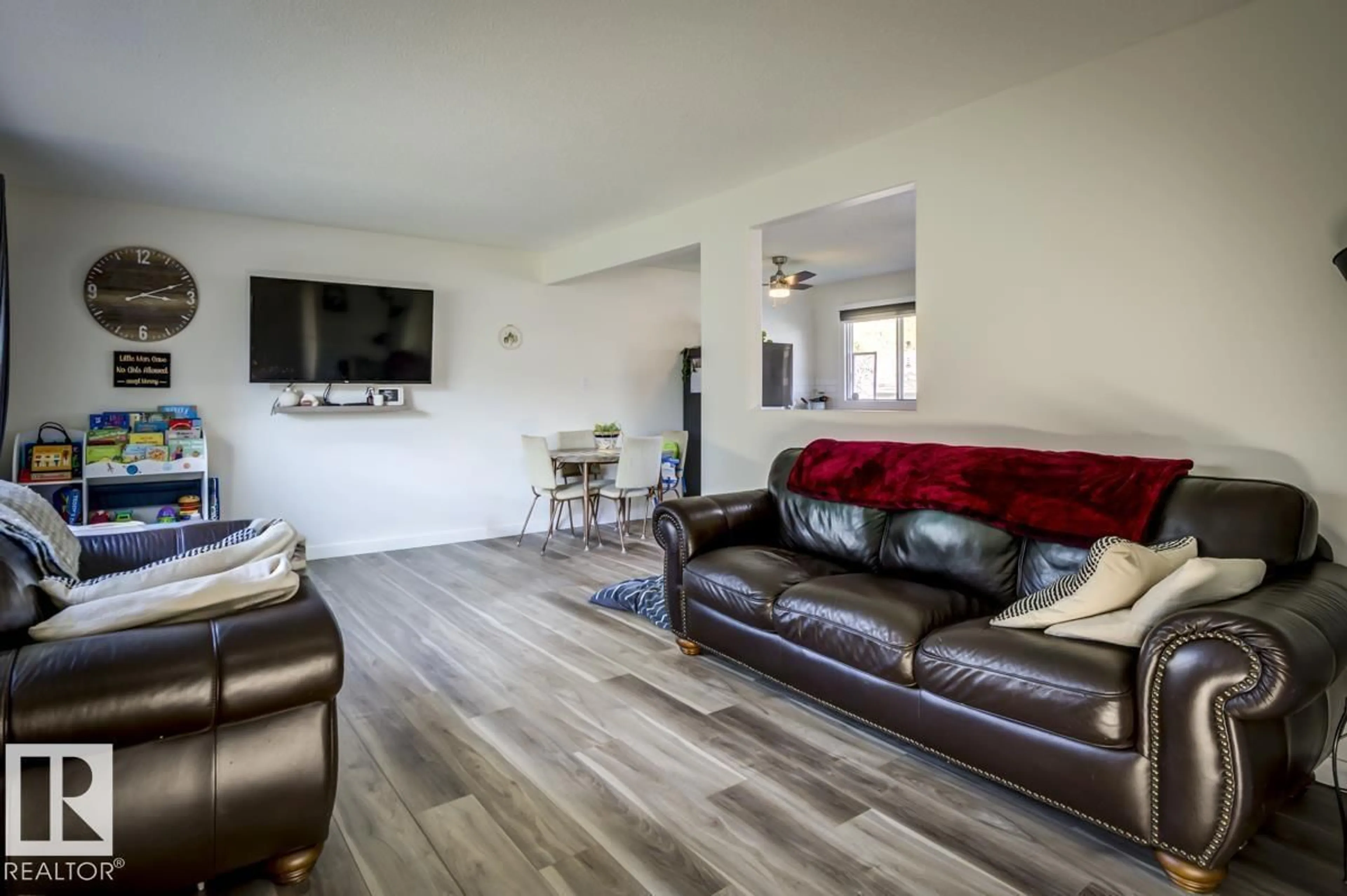 Living room with furniture, wood/laminate floor for 67 CORINTHIA DR, Leduc Alberta T9E4K8