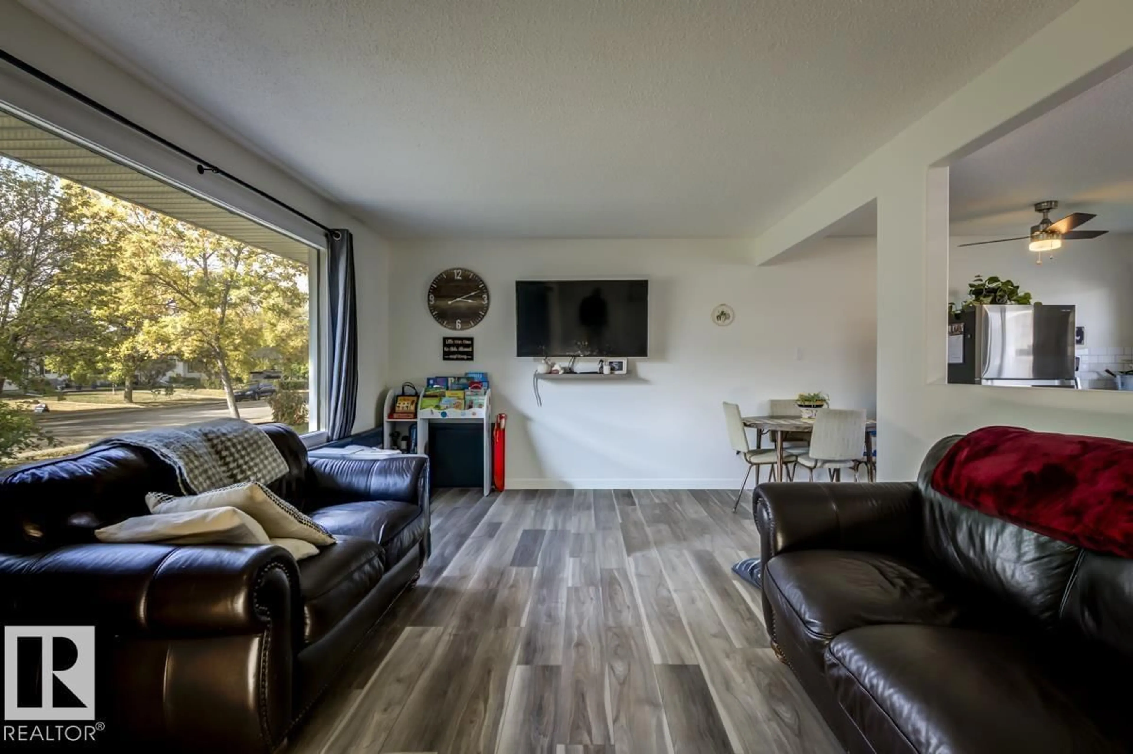 Living room with furniture, wood/laminate floor for 67 CORINTHIA DR, Leduc Alberta T9E4K8