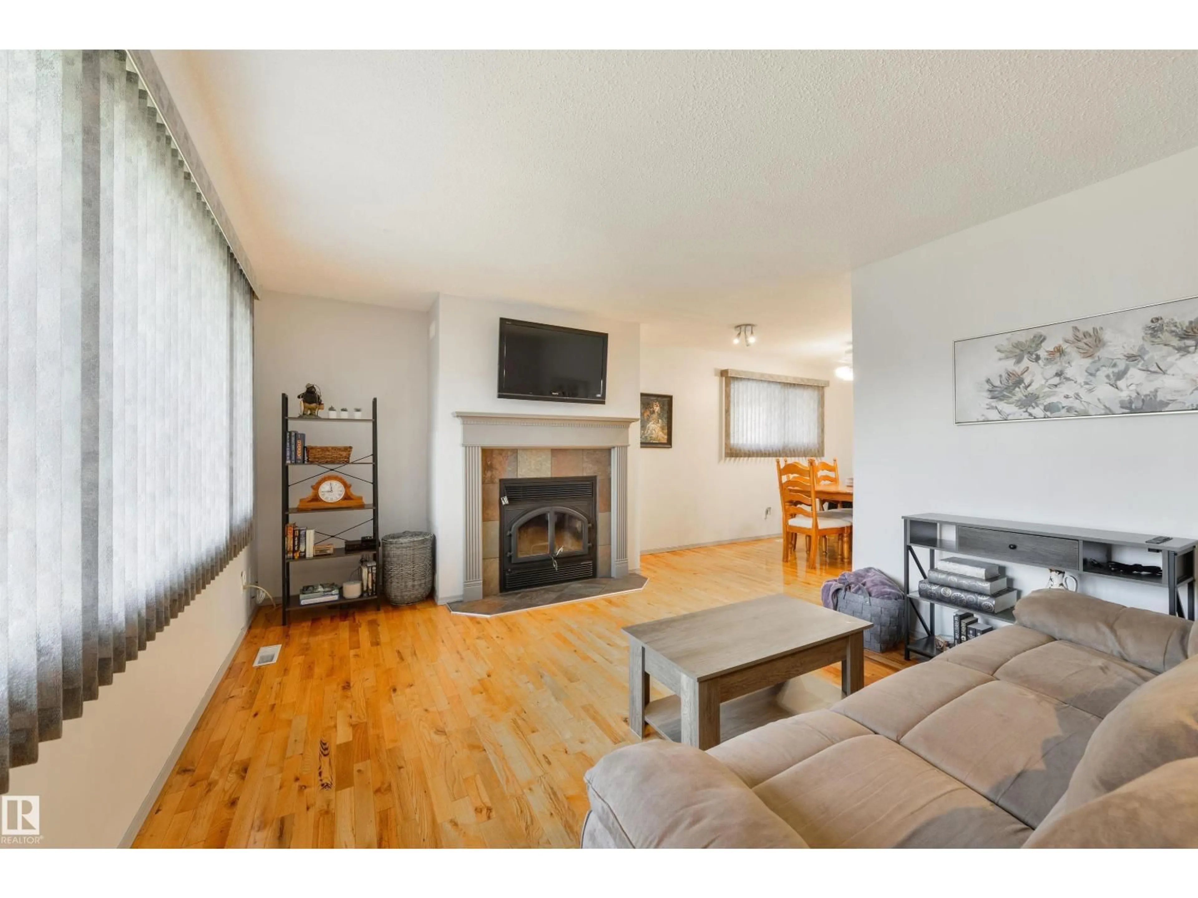 Living room with furniture, wood/laminate floor for NW - 10524 35 AV, Edmonton Alberta T6H4Z5