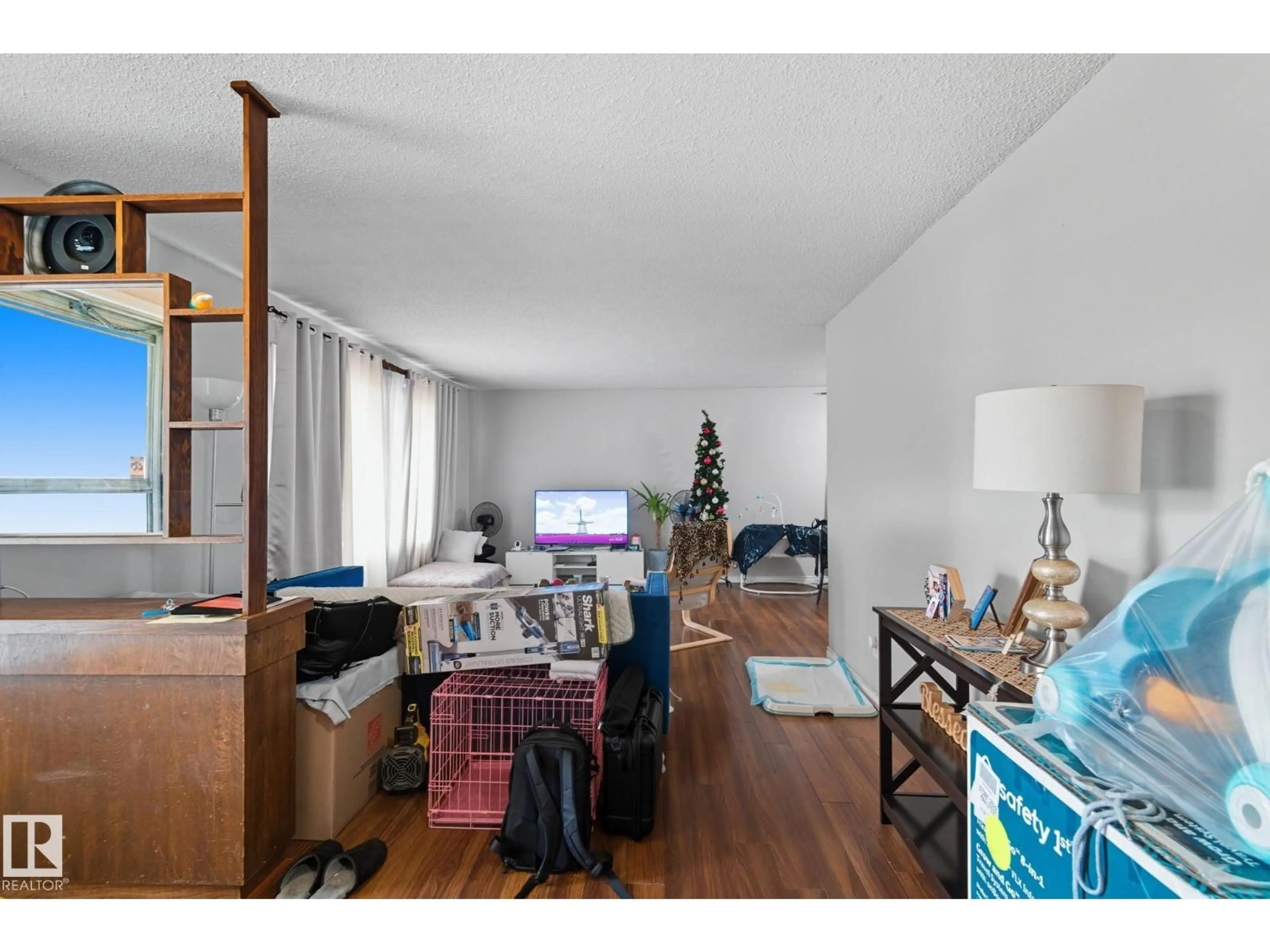 Living room with furniture, wood/laminate floor for 11740 152 AV NW, Edmonton Alberta T5X1S8