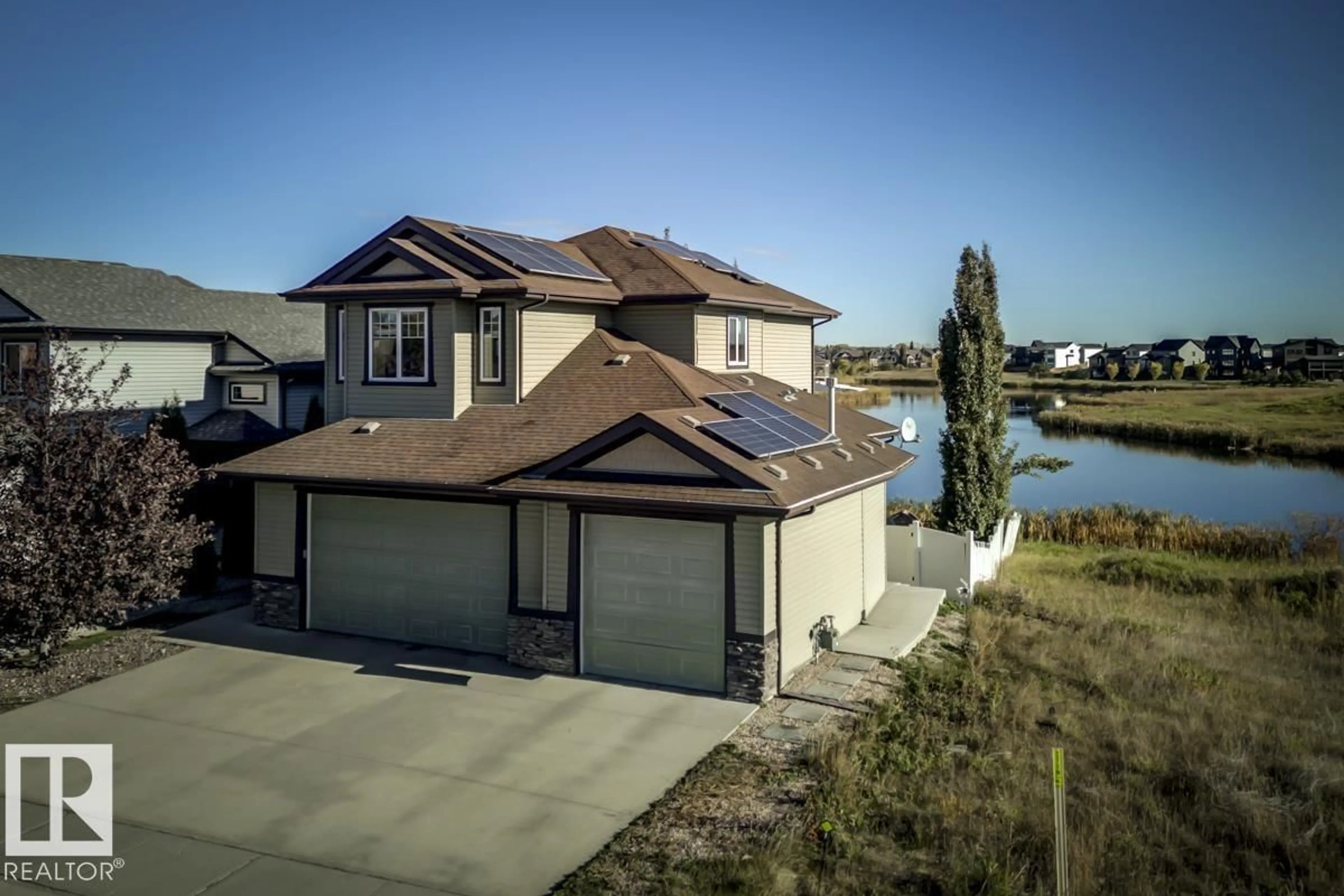 A pic from outside/outdoor area/front of a property/back of a property/a pic from drone, water/lake/river/ocean view for 63 LAKEWOOD BV, Beaumont Alberta T4X0B5