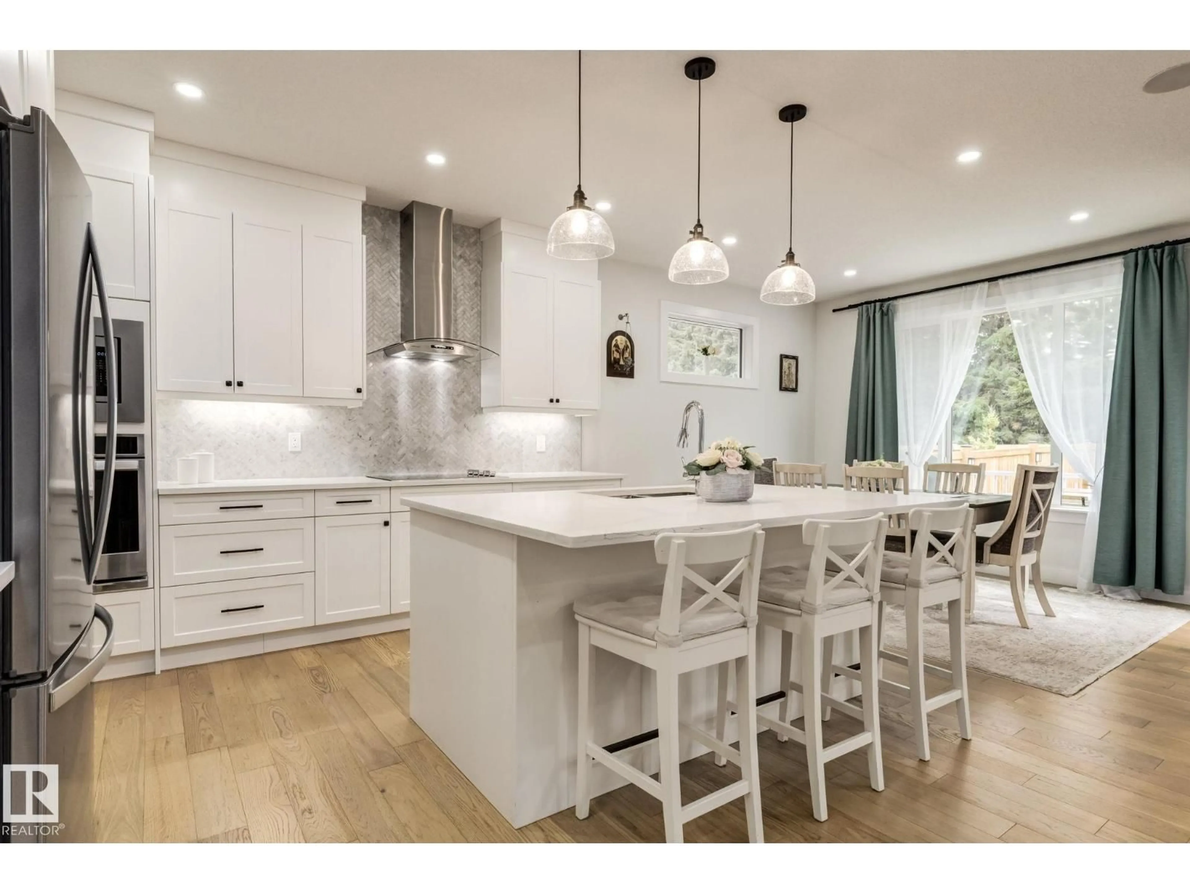 Open concept kitchen, wood/laminate floor for SW - 16311 34 AV, Edmonton Alberta T6W4V7