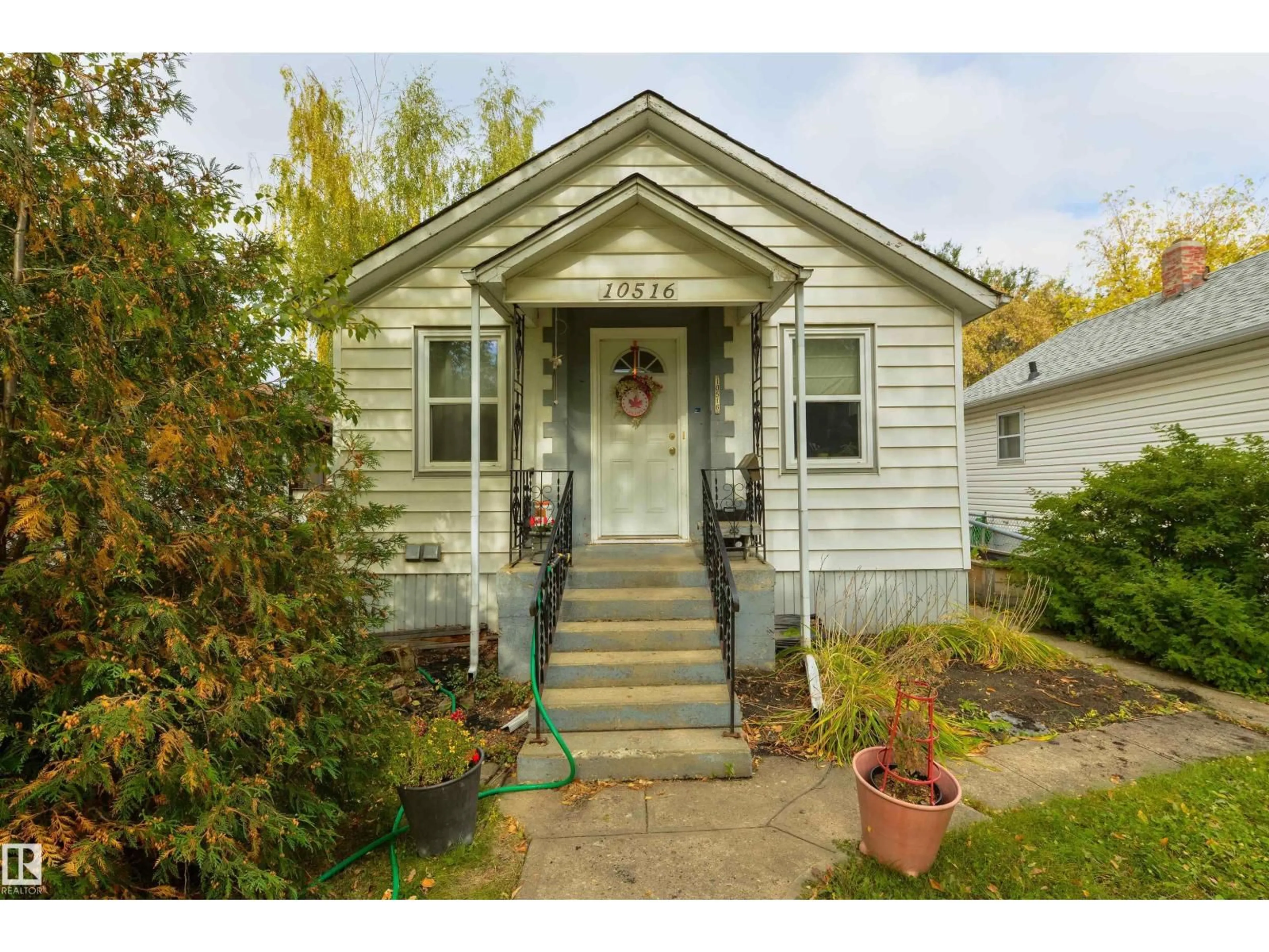 Home with vinyl exterior material, street for 10516 74 AV, Edmonton Alberta T6E1G2