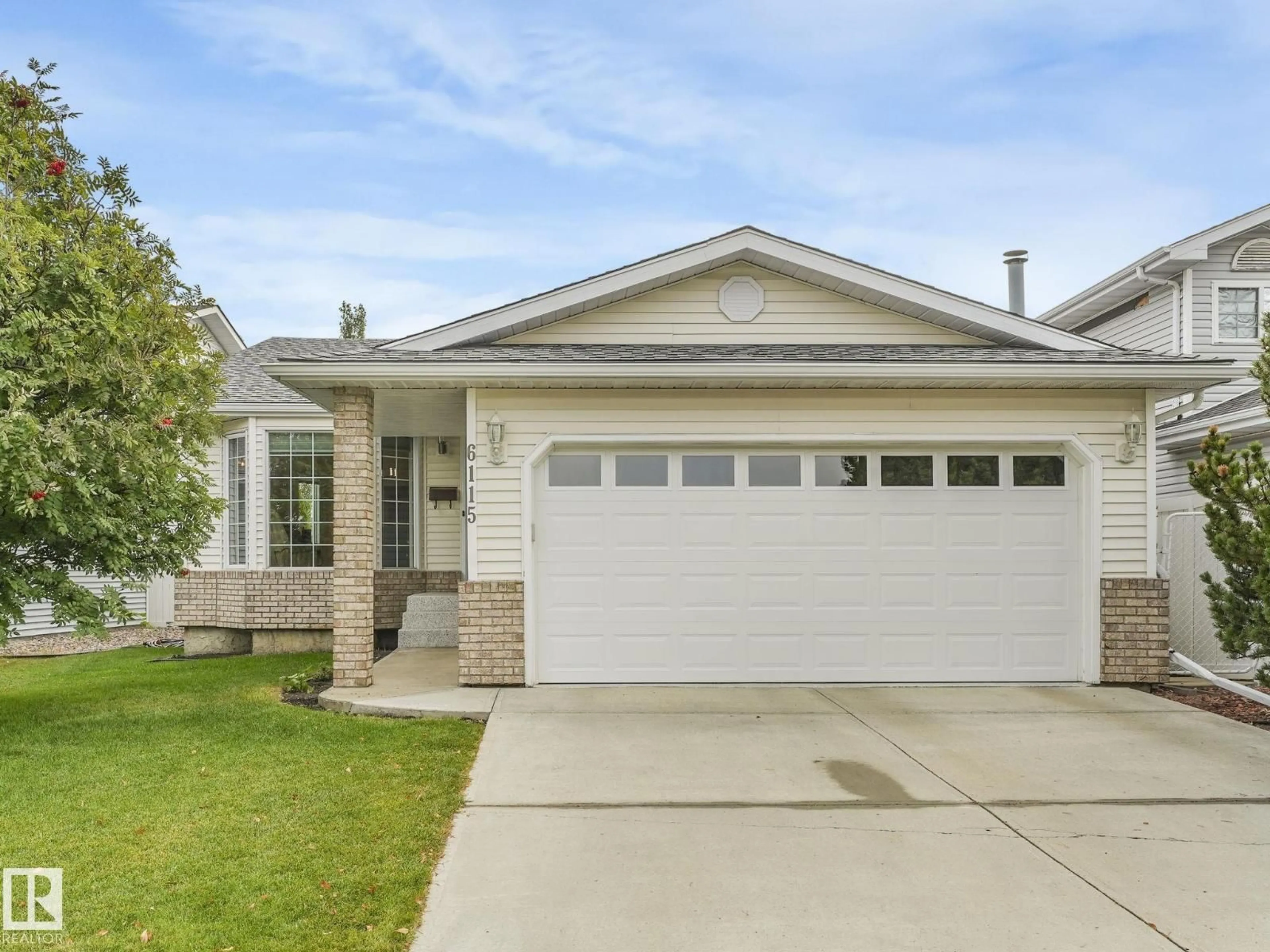 Home with vinyl exterior material, street for 6115 157 AV NW, Edmonton Alberta T5Y2P5