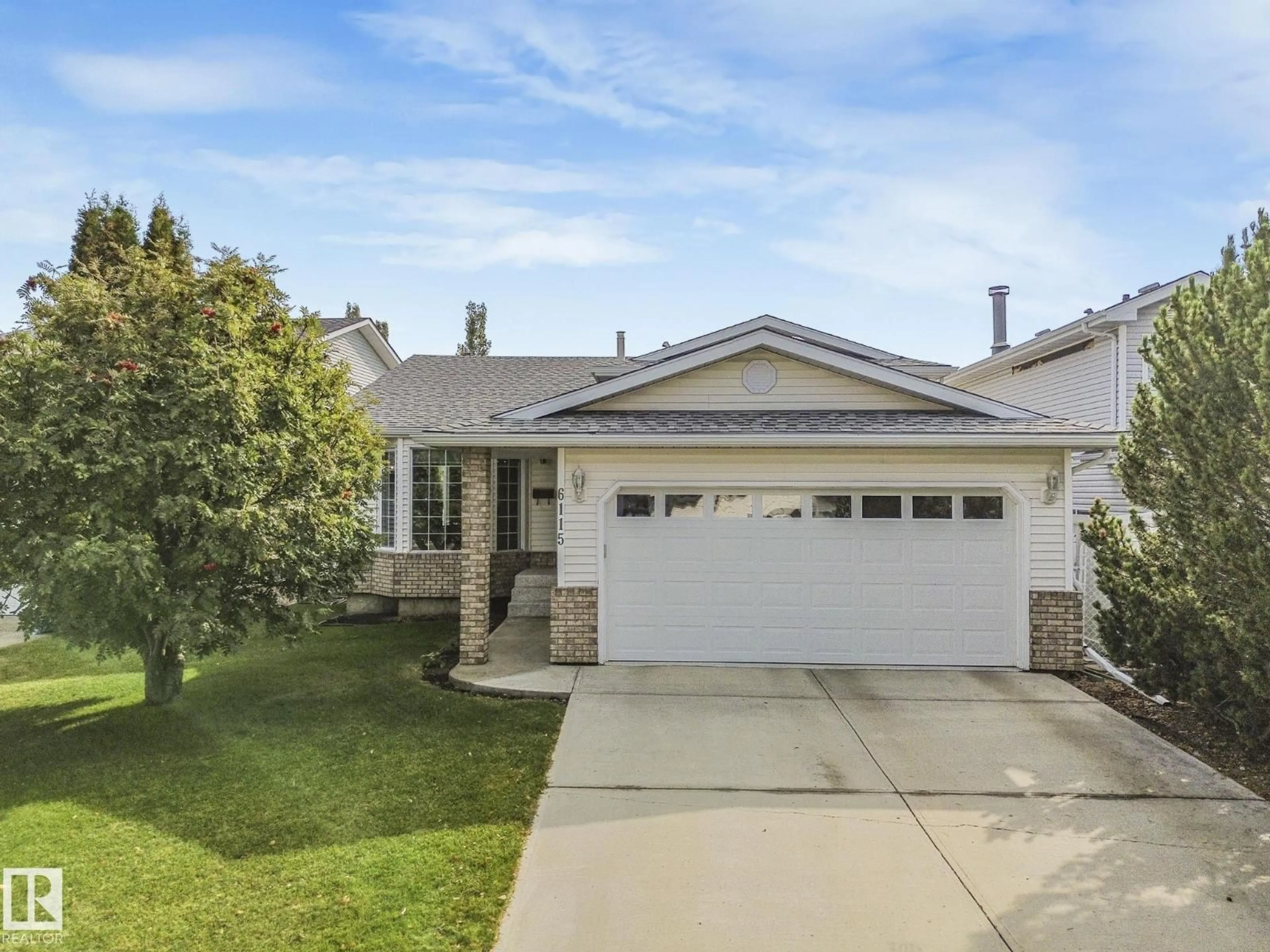Home with vinyl exterior material, street for 6115 157 AV NW, Edmonton Alberta T5Y2P5