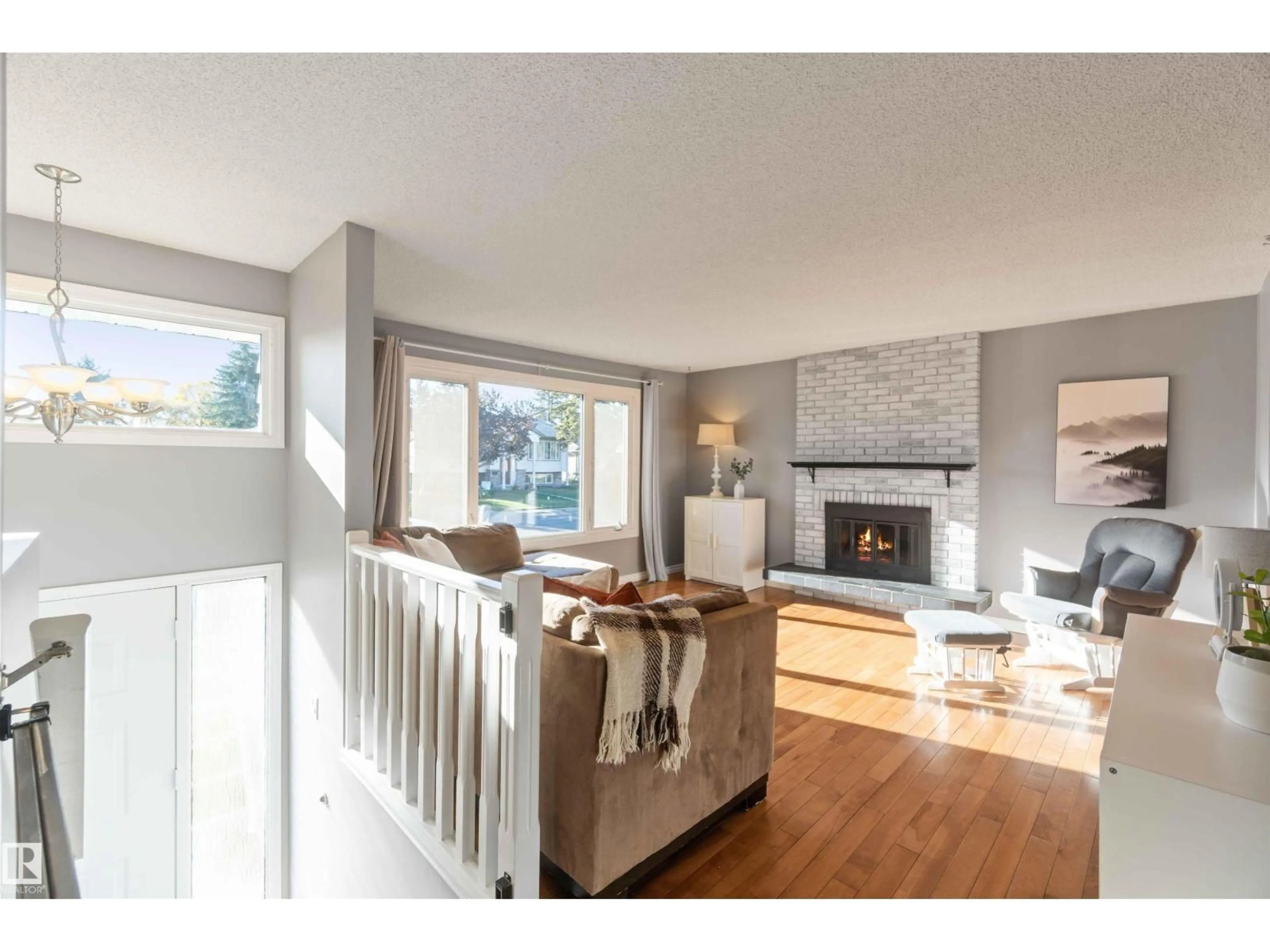 Living room with furniture, wood/laminate floor for 8508 43 AV, Edmonton Alberta T6K1B1