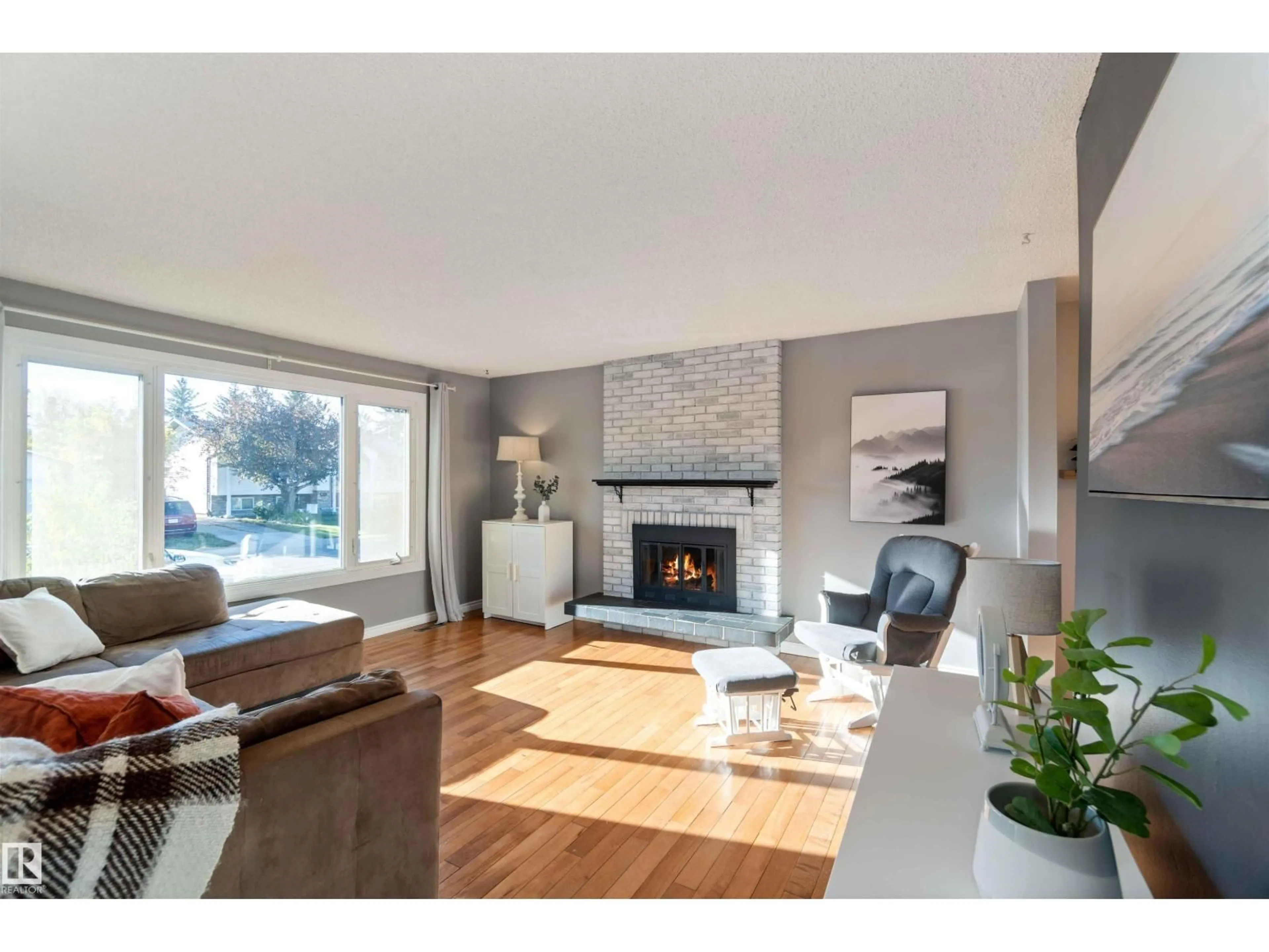 Living room with furniture, wood/laminate floor for 8508 43 AV, Edmonton Alberta T6K1B1