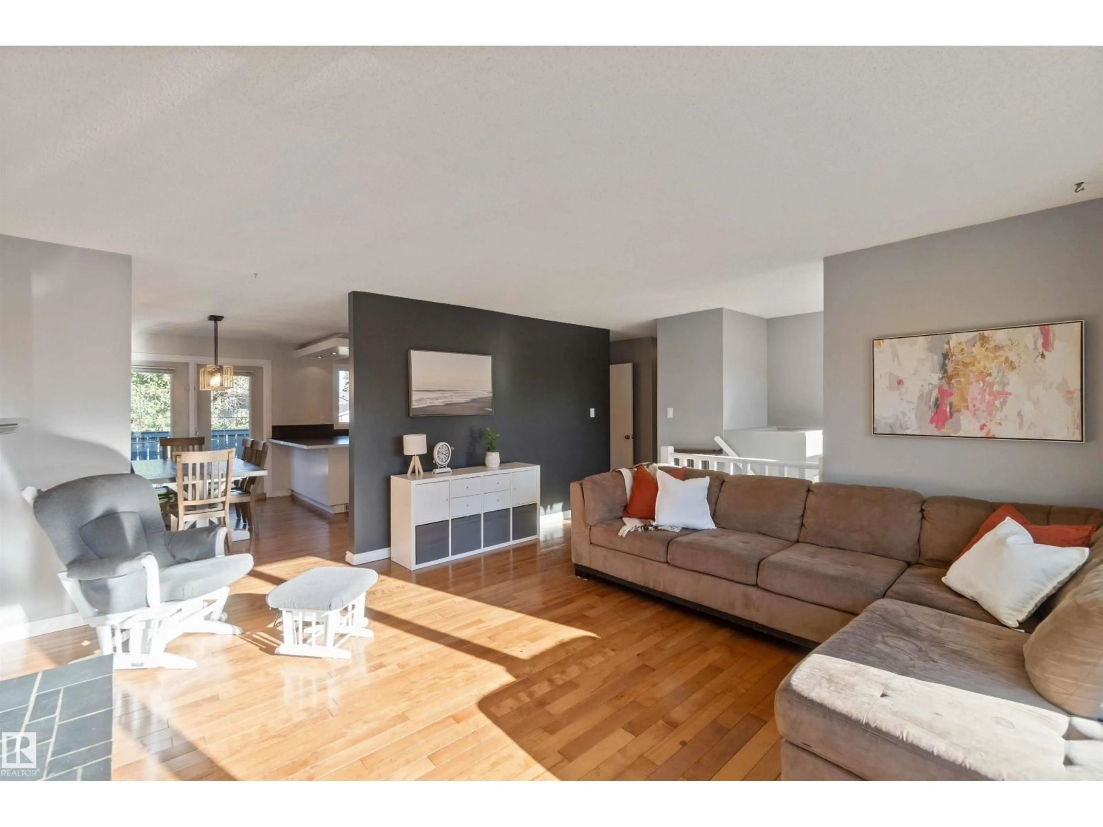 Living room with furniture, wood/laminate floor for 8508 43 AV, Edmonton Alberta T6K1B1