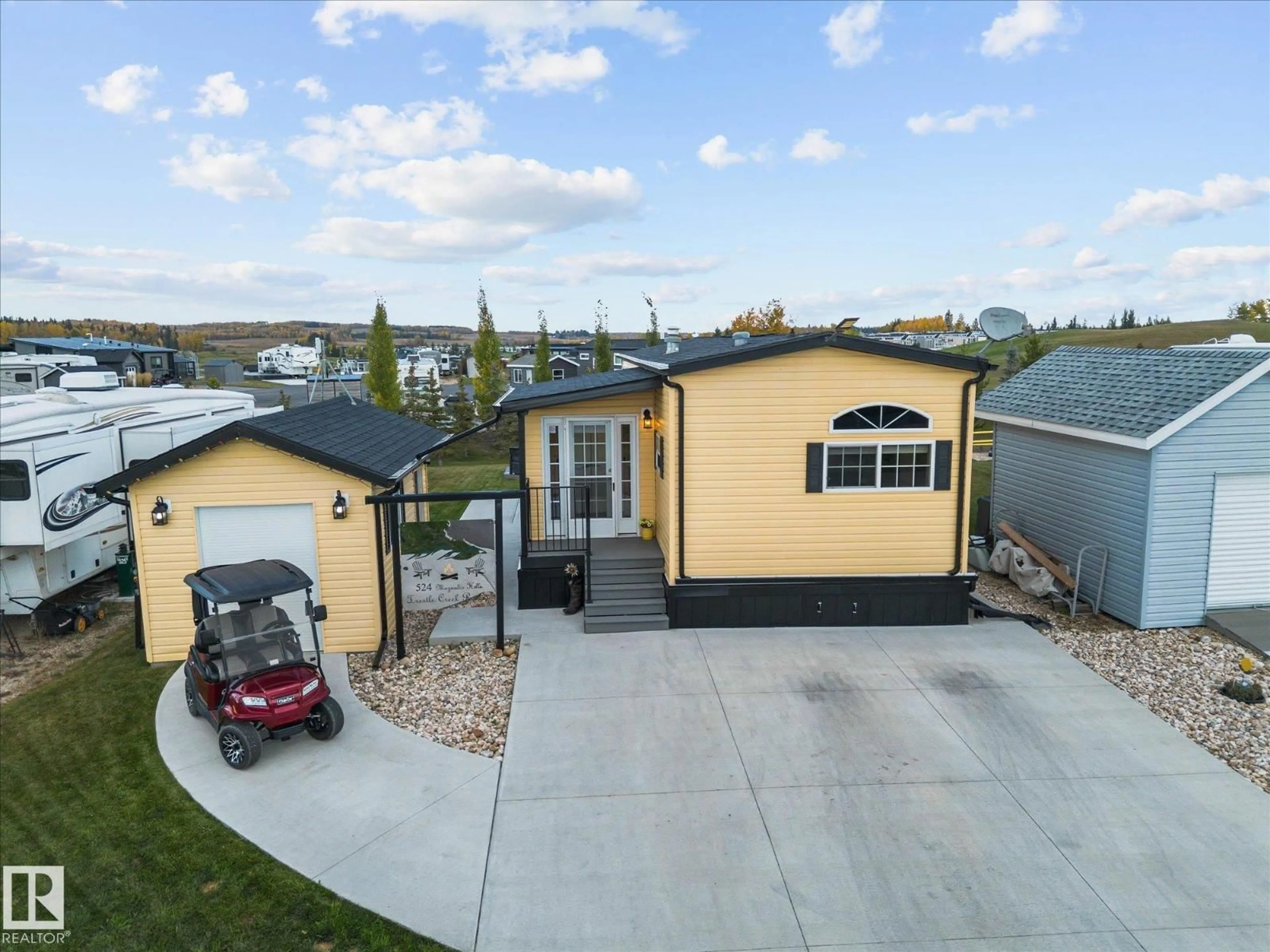 A pic from outside/outdoor area/front of a property/back of a property/a pic from drone, street for 524 - 53126 RGE ROAD 70, Rural Parkland County Alberta T0E0S0