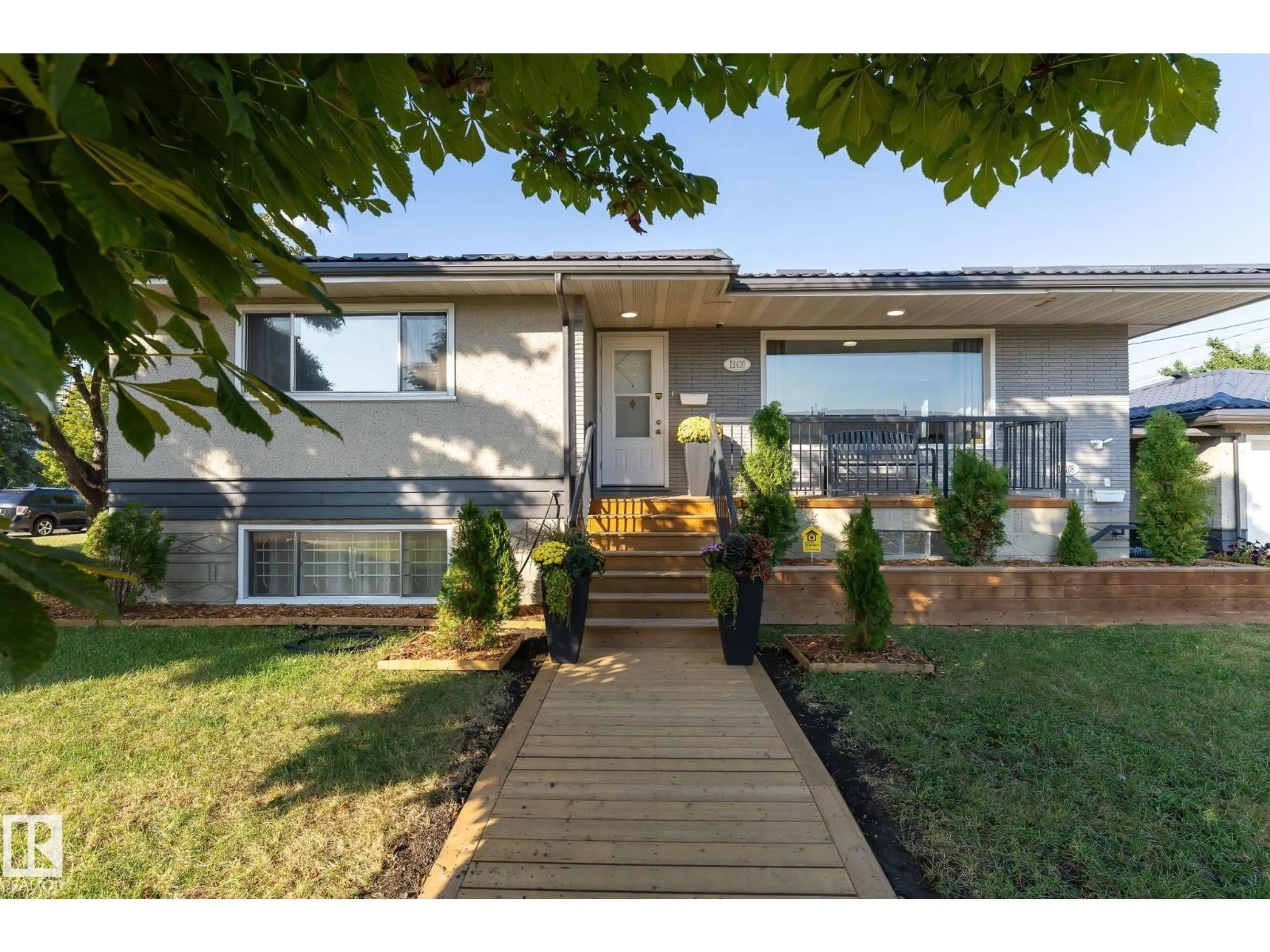 Home with vinyl exterior material, street for 12410 134 AV, Edmonton Alberta T5J3Y4