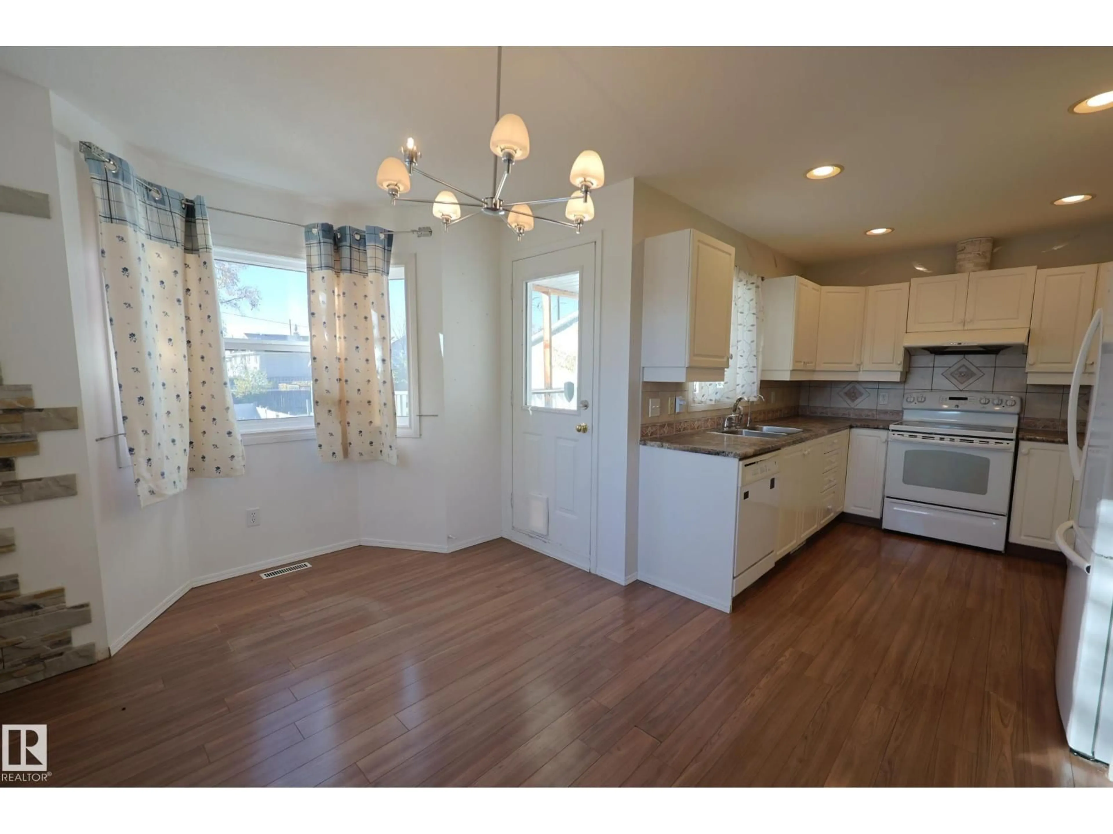 Open concept kitchen, wood/laminate floor for 9447 156 ST, Edmonton Alberta T5R1Z5