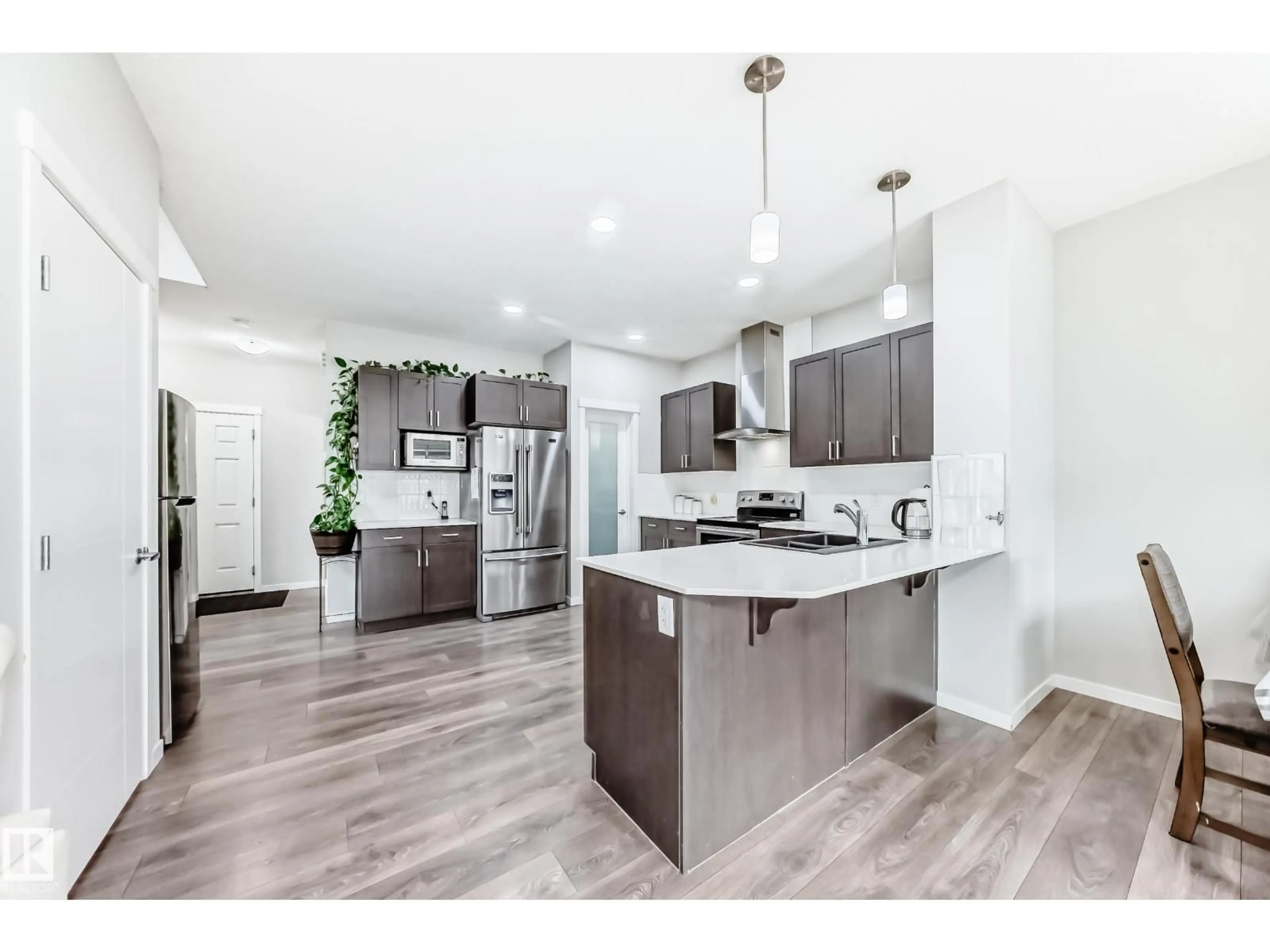 Open concept kitchen, wood/laminate floor for NW - 12212 176 AV, Edmonton Alberta T5X0L2