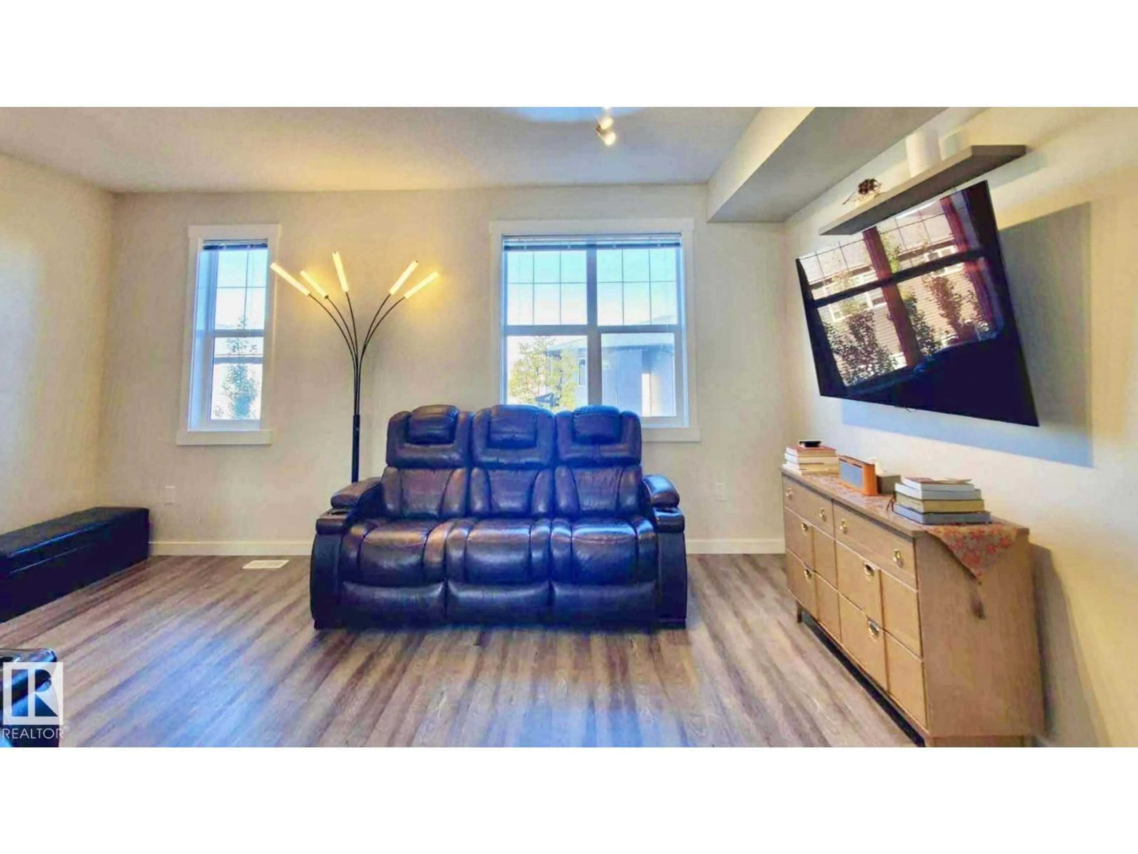 Living room with furniture, wood/laminate floor for 903 - 36 CRYSTALLINA NERA WY, Edmonton Alberta T5Z0N6
