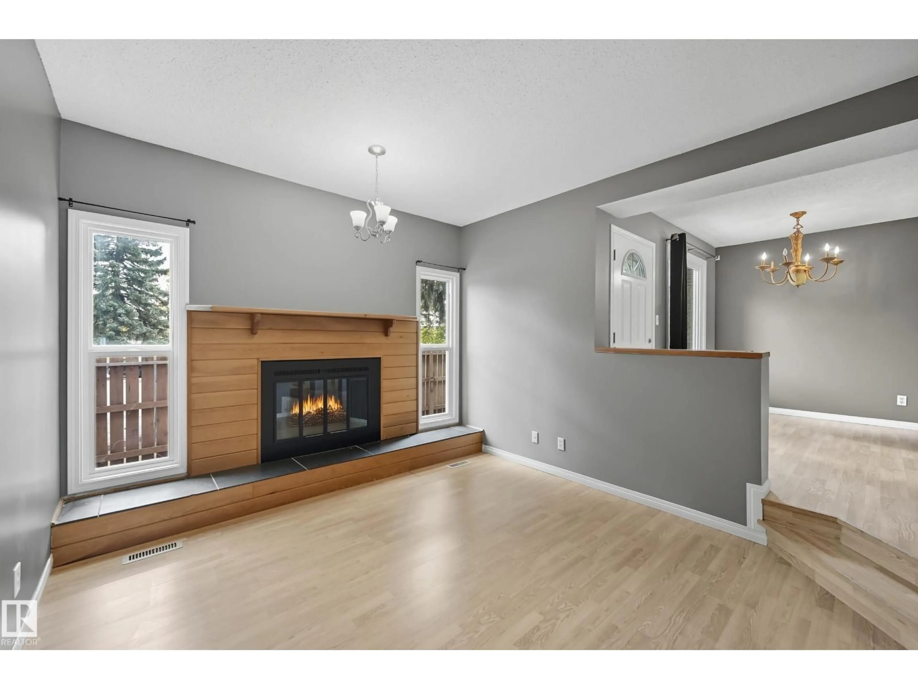 Living room with furniture, wood/laminate floor for NW - 17020 100 ST, Edmonton Alberta T5X5E1