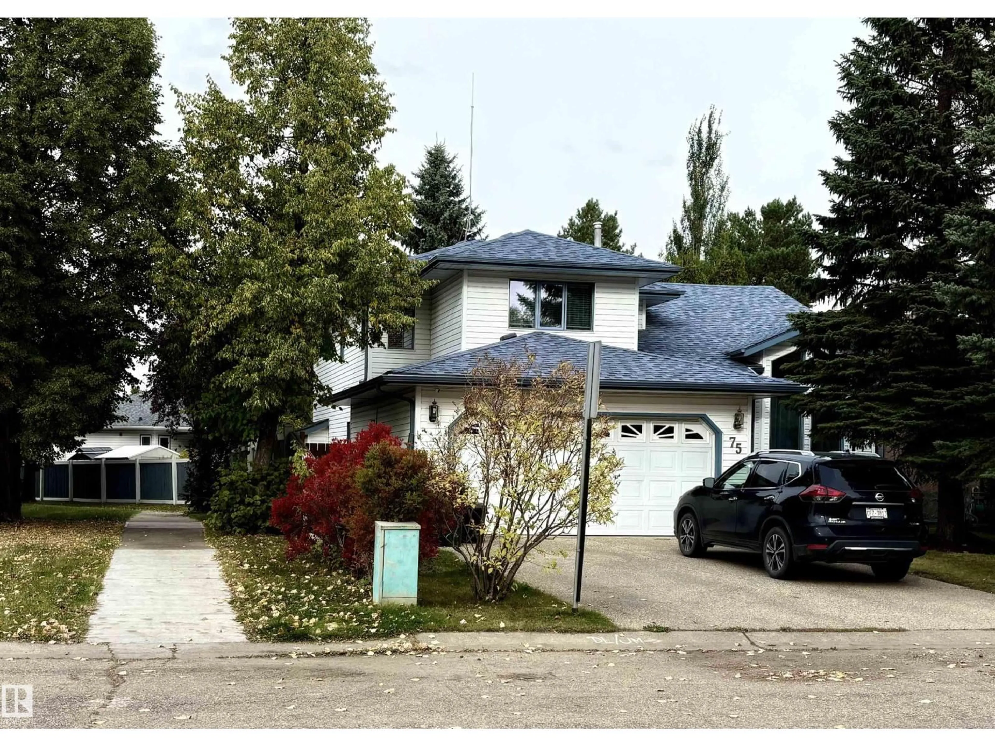 Home with vinyl exterior material, street for 75 WOODSIDE CR, Spruce Grove Alberta T7X3E6